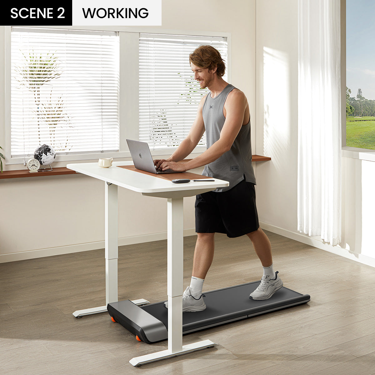Man walking on the WalkingPad P1 treadmill under a standing desk setup.