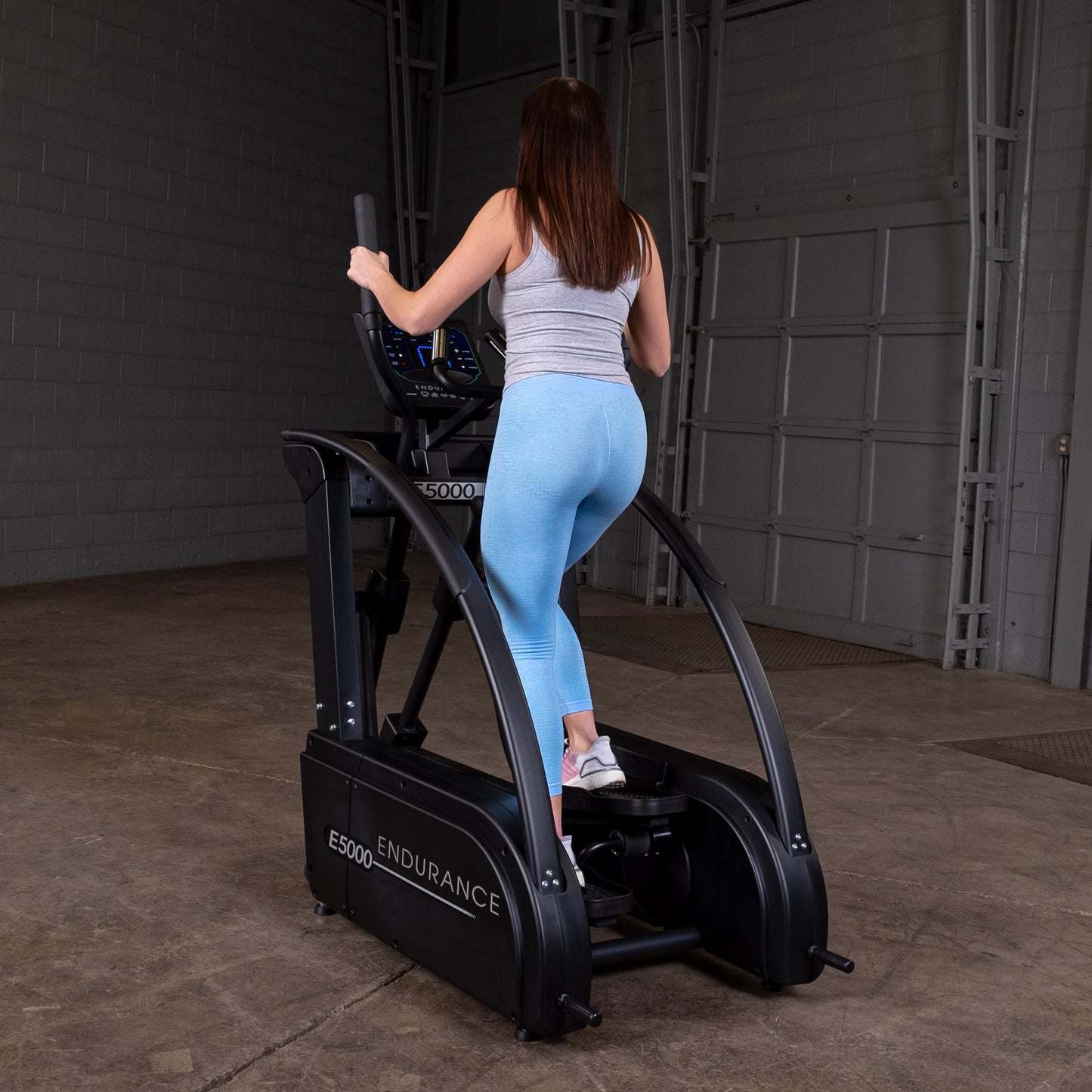 Endurance E5000 elliptical setup in a modern home gym environment with mat flooring