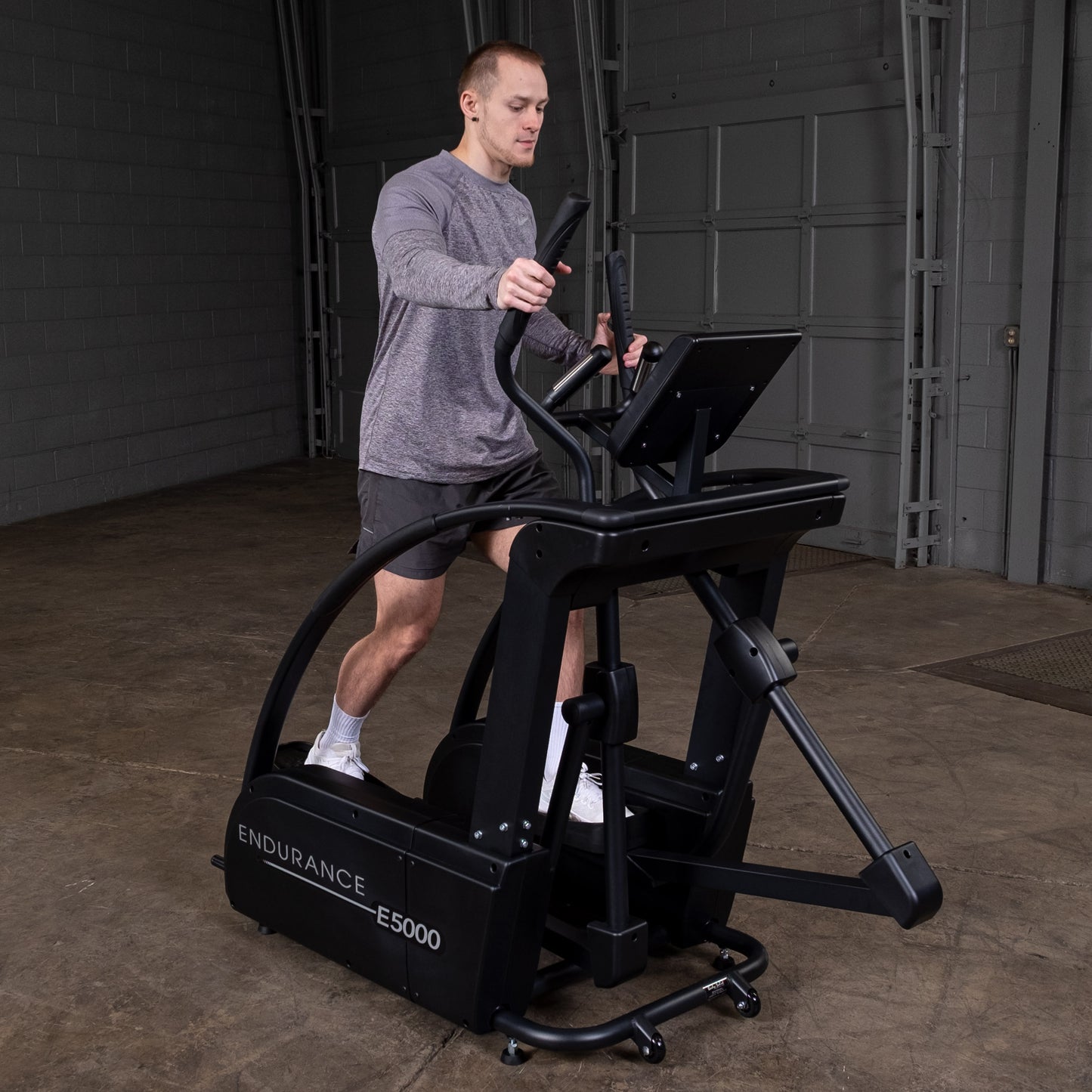 Endurance E5000 elliptical setup in a modern home gym environment with mat flooring