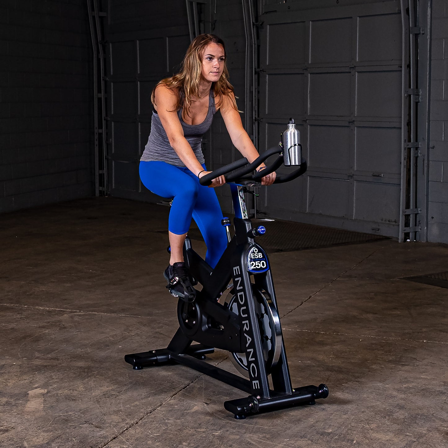 Woman spinning on the Endurance by Body-Solid ESB250 Spin Bike