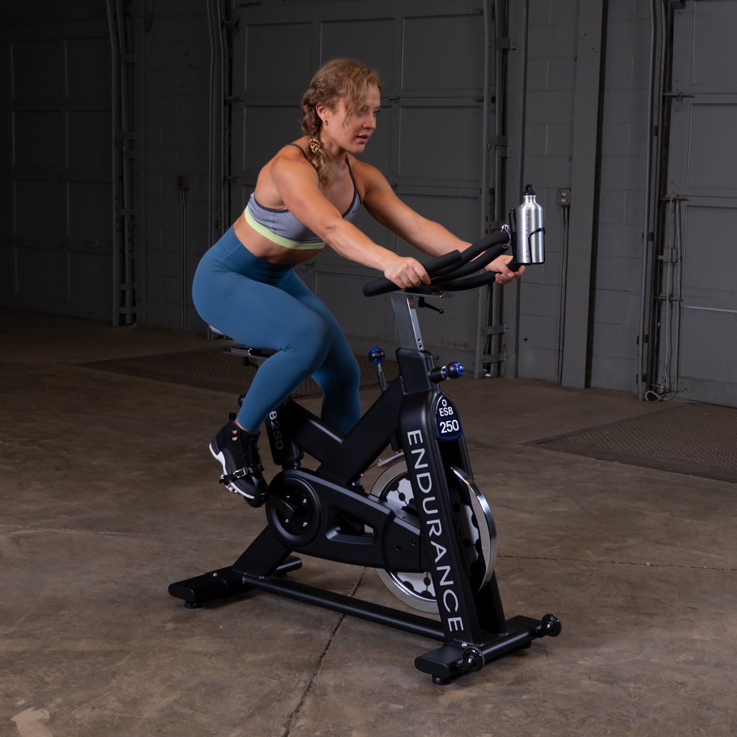 Body-Solid Endurance ESB250 spin bike set up in a modern home gym environment