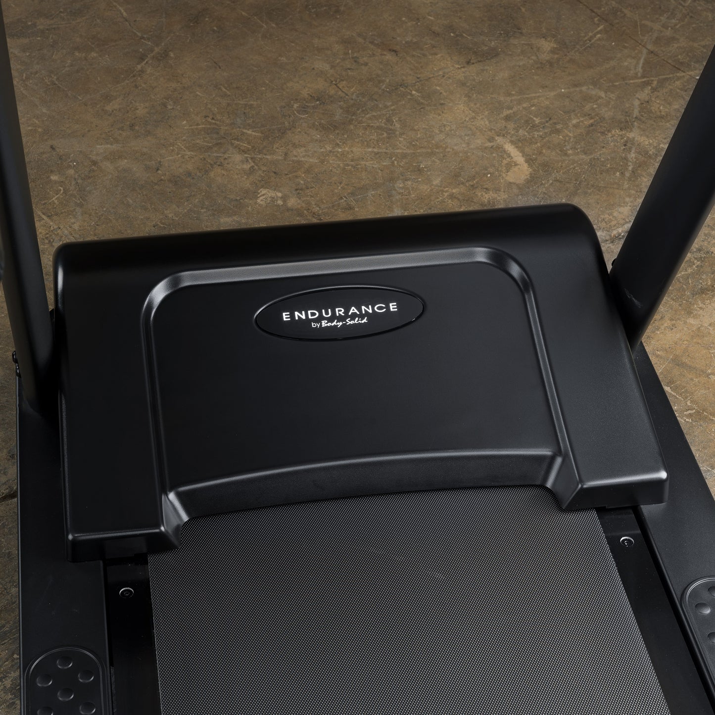 Durable, shock-absorbing running deck of the Body-Solid T150 treadmill designed for commercial use