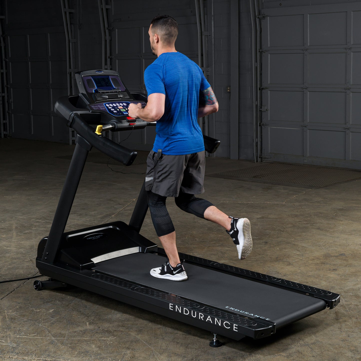 Man running on the Body-Solid Endurance T150 Commercial Treadmill