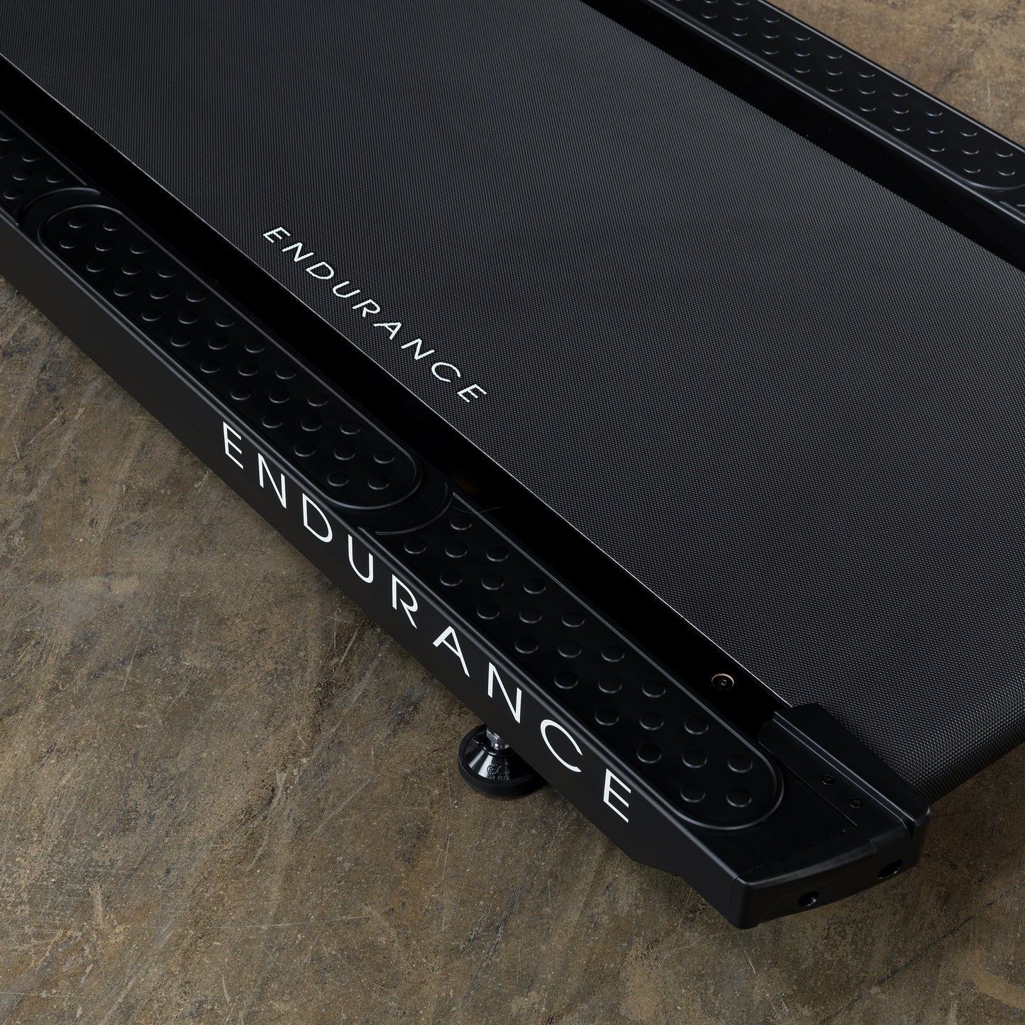 Durable, shock-absorbing running deck of the Body-Solid T150 treadmill designed for commercial use