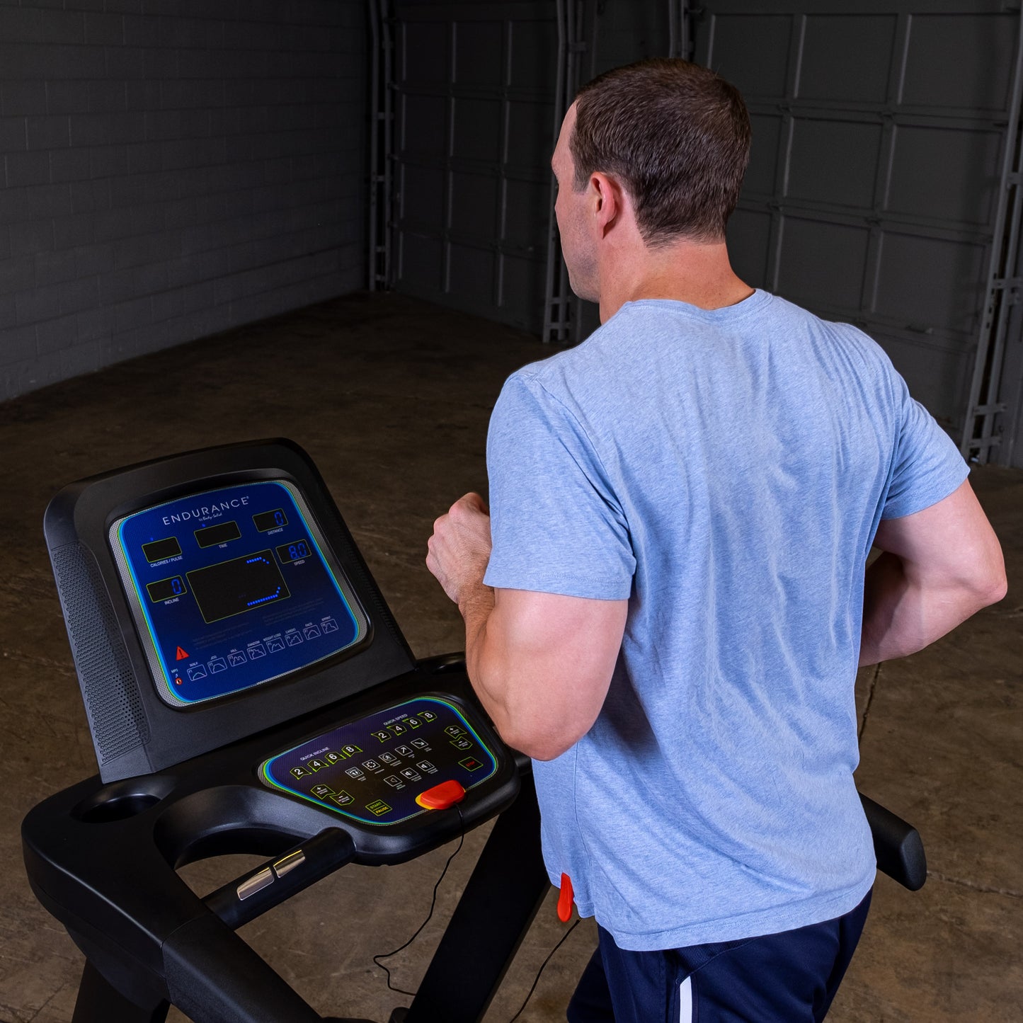 Person jogging on the Body-Solid Endurance T25 Folding Treadmill during a home workout.