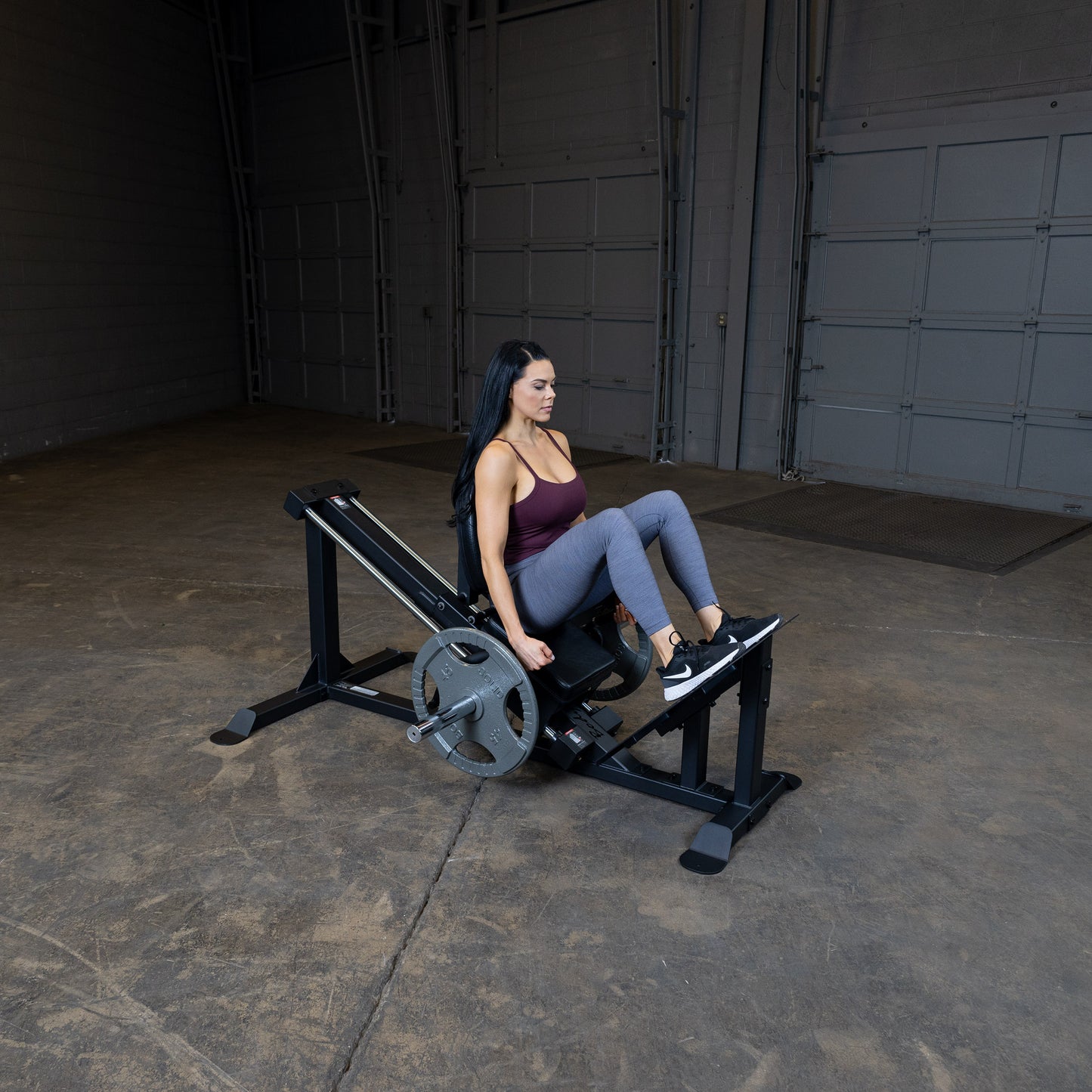 User performing leg press on Body-Solid GCLP100