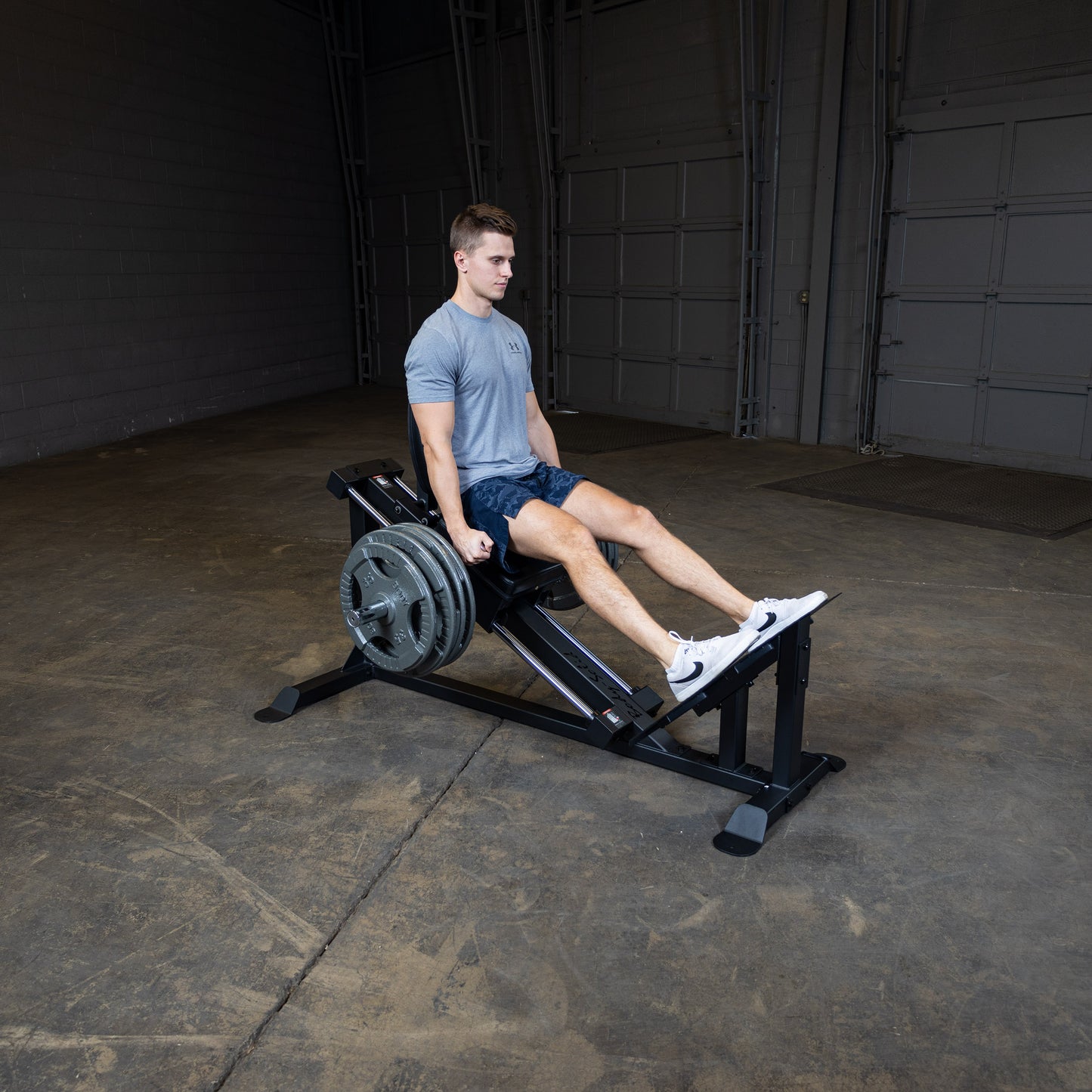 User performing leg press on Body-Solid GCLP100