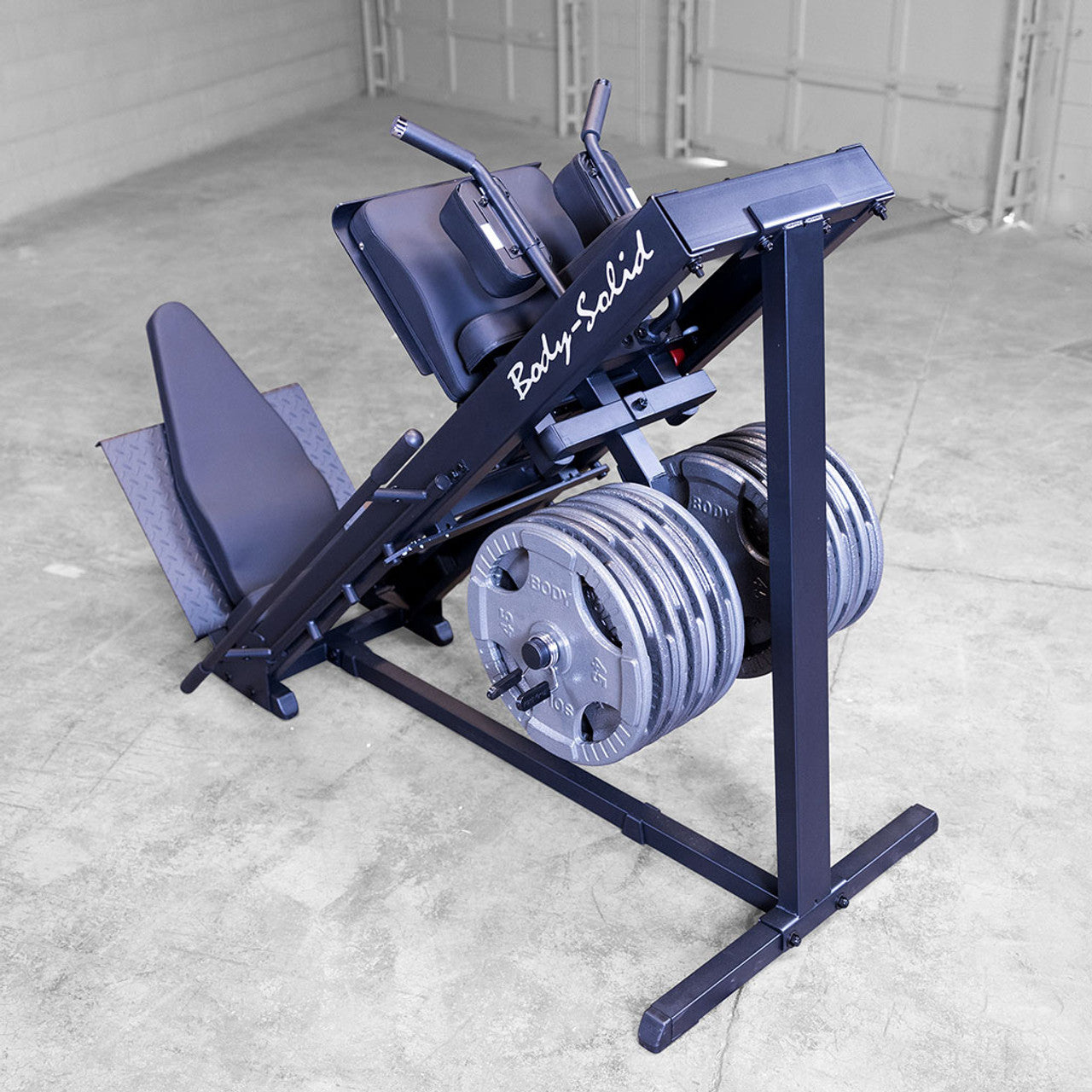 Full view of Body‑Solid GLPH1100B loaded with plates for leg press