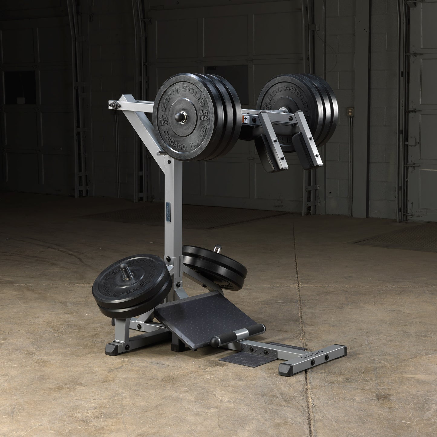 Body-Solid GSCL360 fully loaded with Olympic weight plates for intense leg training.