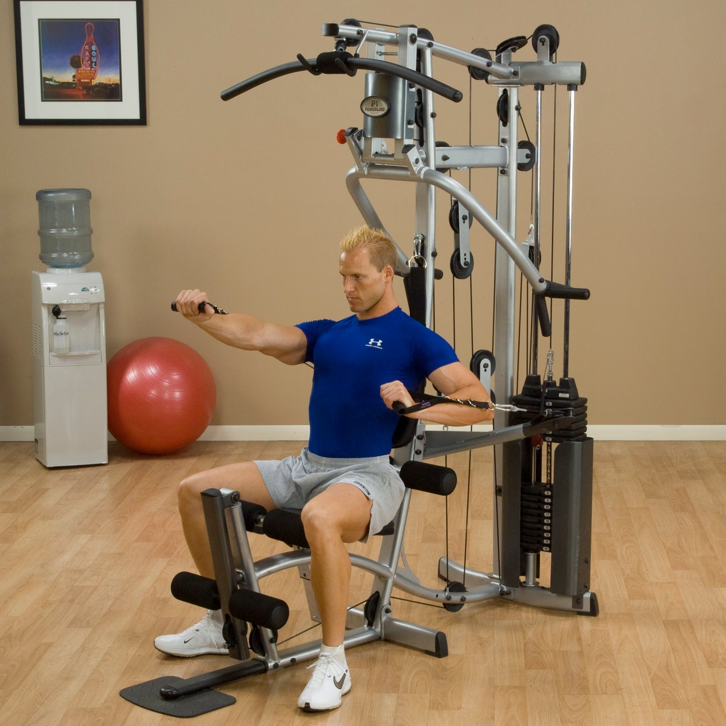 Person using the Body-Solid Powerline P2X Home Gym for chest press exercise