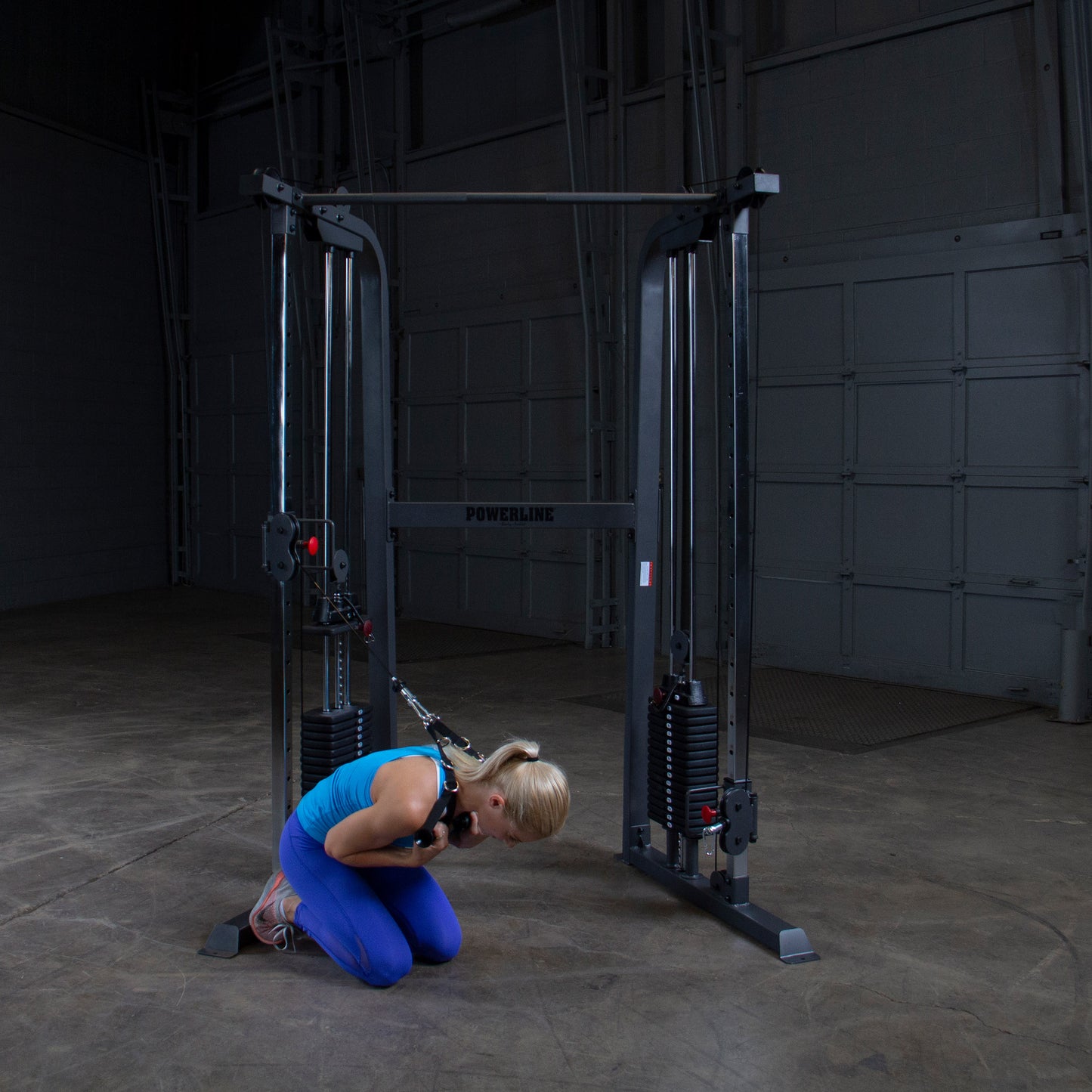 Compact space-saving design of Body-Solid Powerline PFT100 Functional Trainer ideal for home or garage gyms.