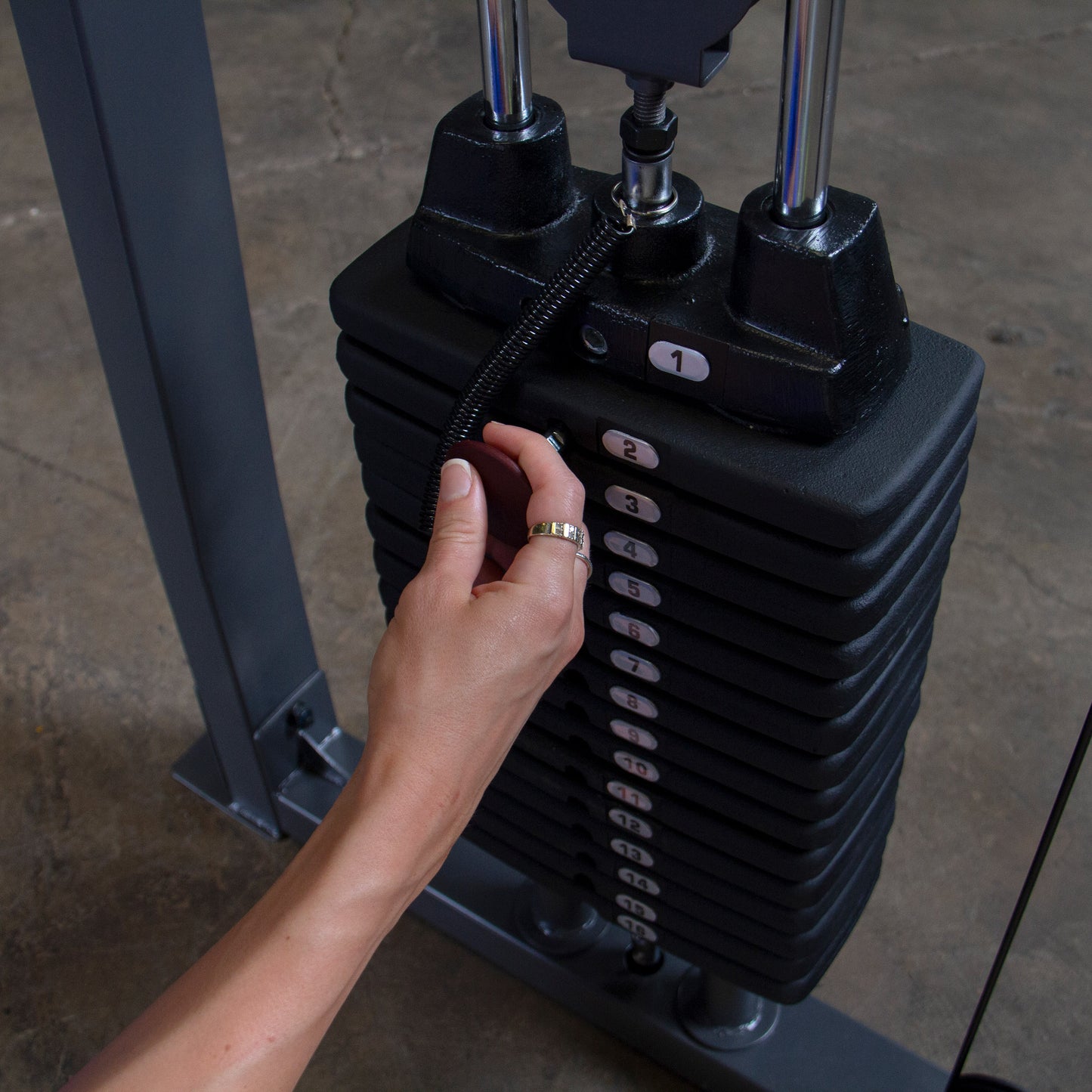 Close-up of weight stack on Body-Solid Powerline PFT100 Functional Trainer showing 160 lb dual resistance system.
