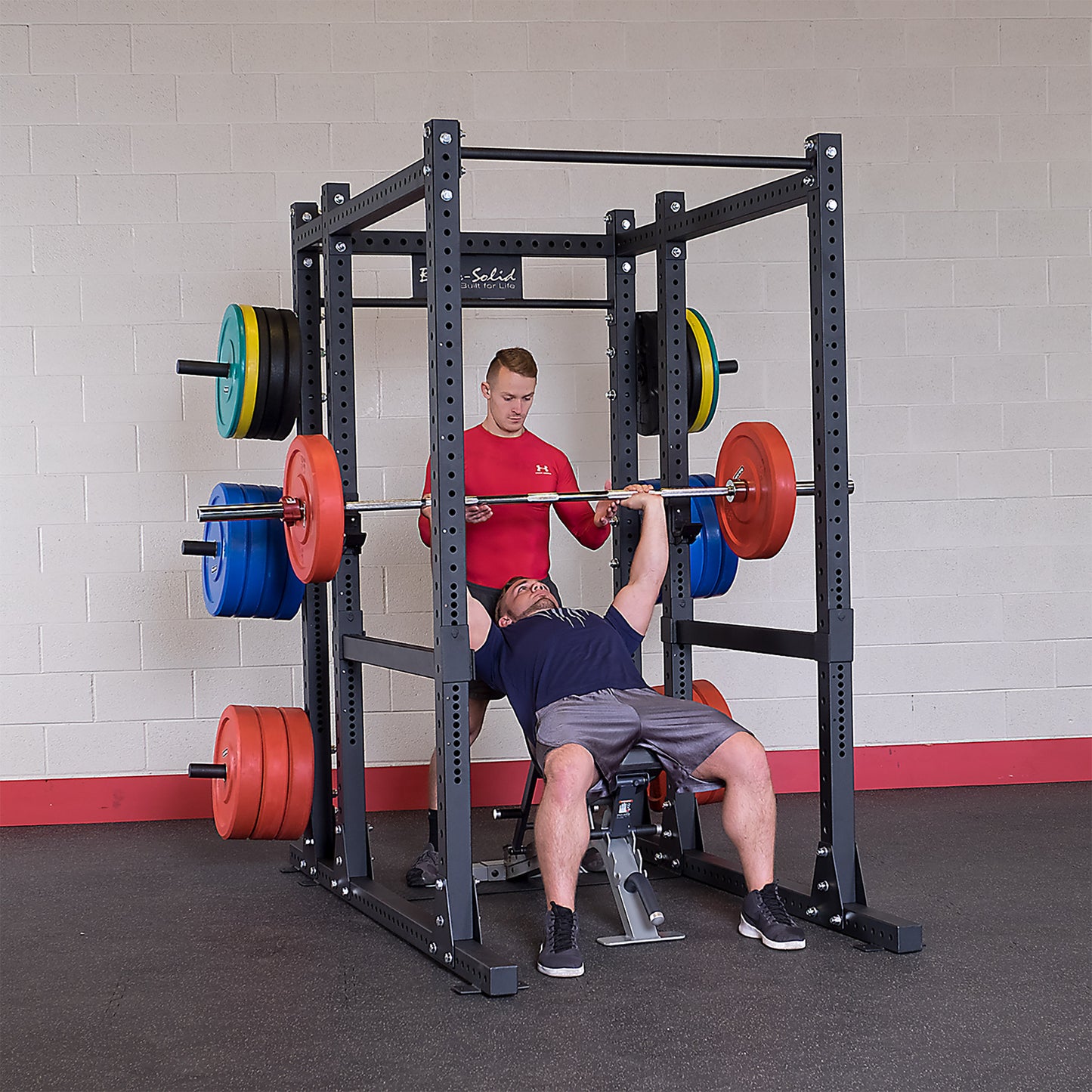 Man performing bench press on the Body-Solid SPR1000 Power Rack