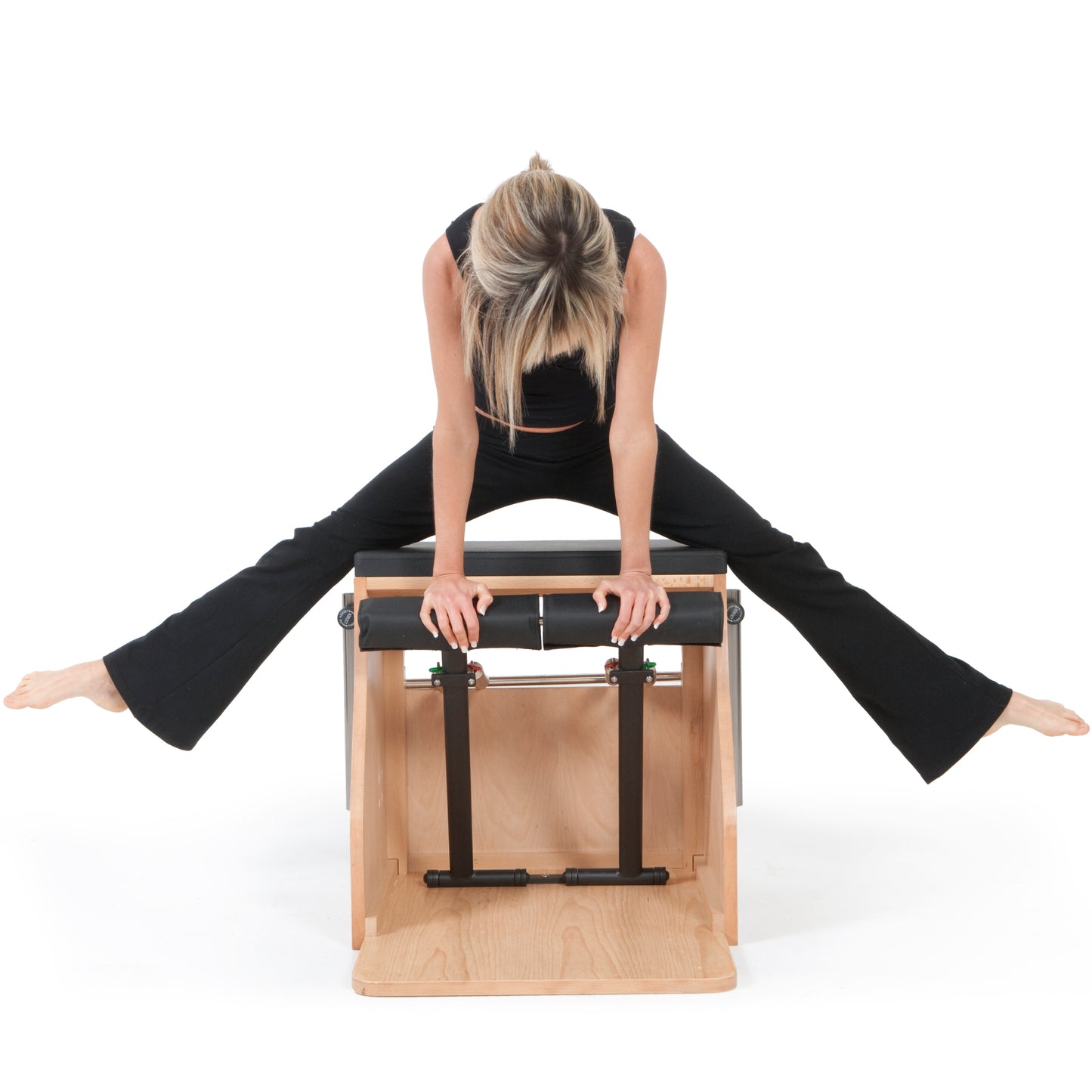 Practitioner performing Pilates exercises on the Elina Wood Combo Chair