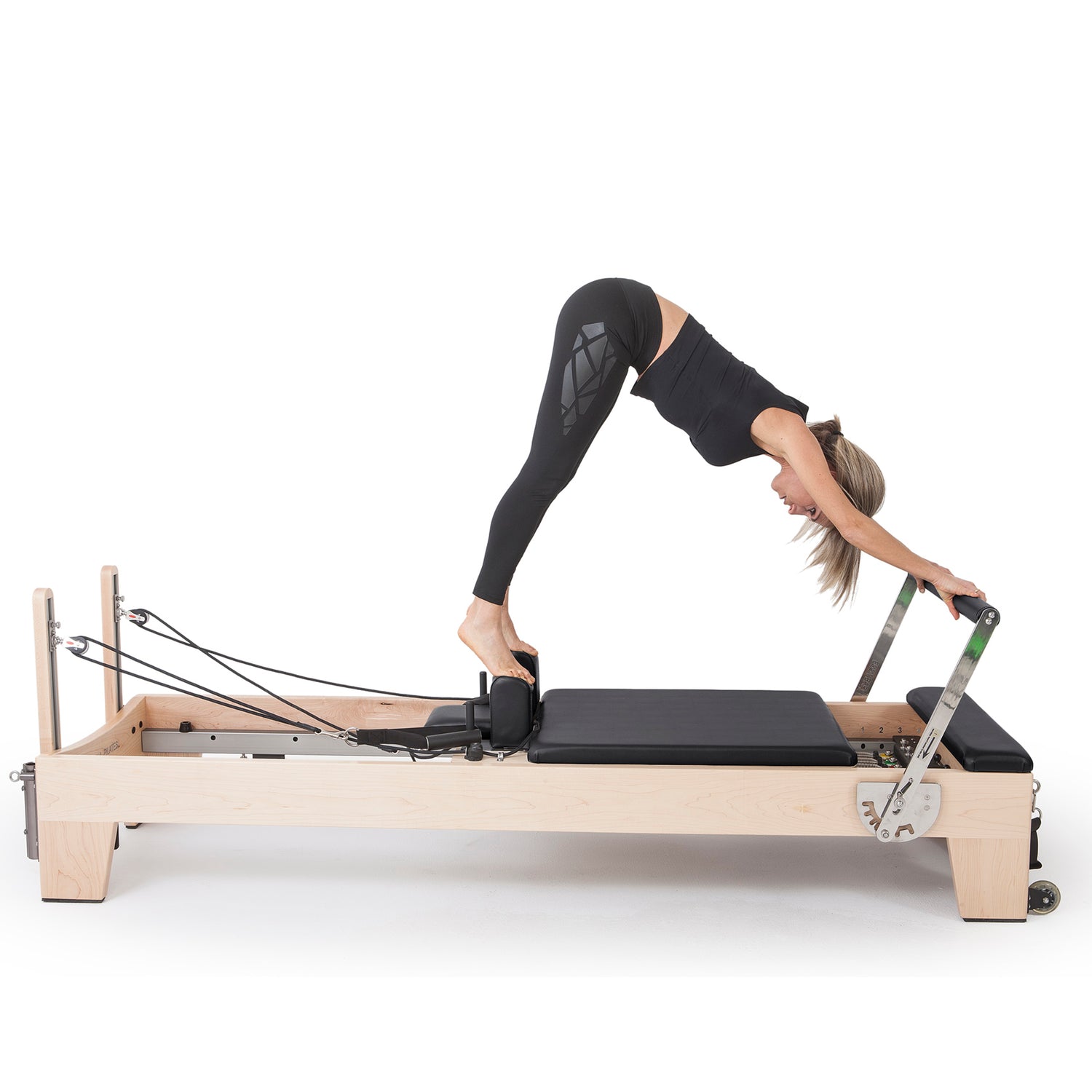 Pilates instructor performing core strengthening exercises on Elina Pilates Elite Wood Reformer with black upholstery