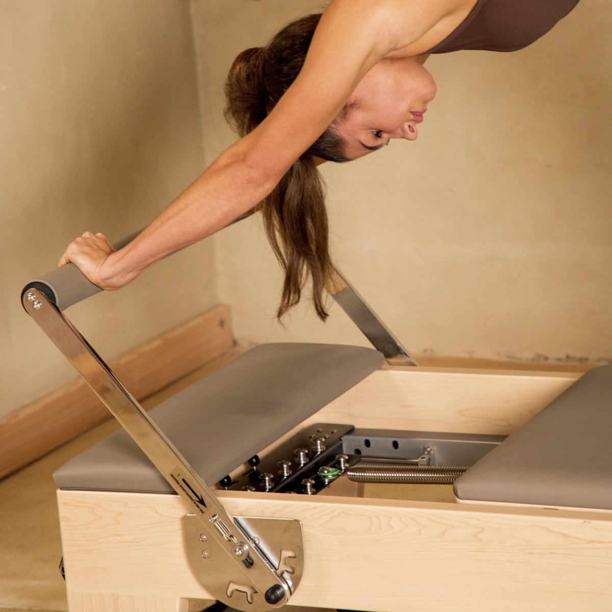 Pilates instructor performing strengthening exercises on Elina Pilates Elite Wood Reformer