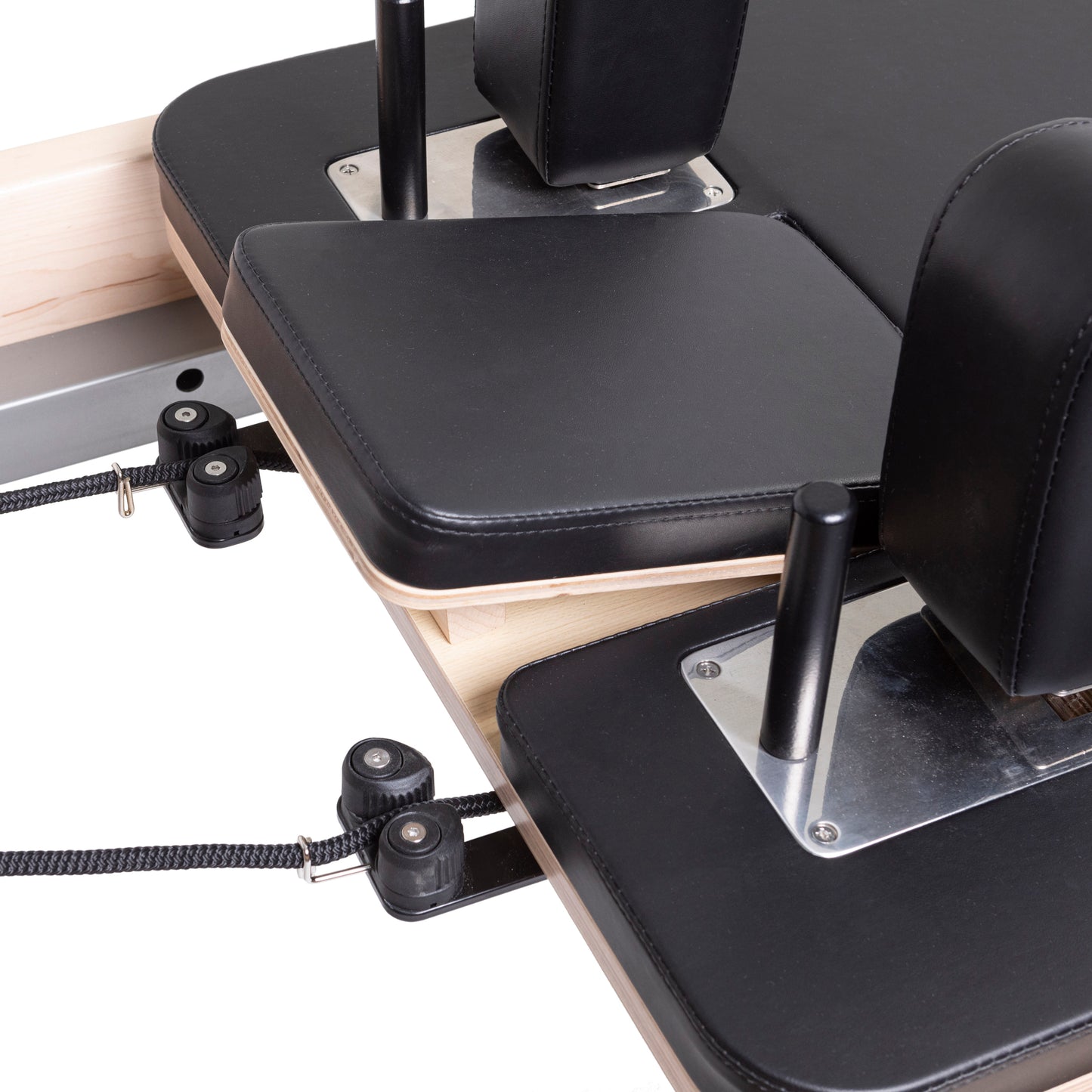 Padded shoulder rests with premium black upholstery on the Master Instructor™ Pilates Reformer for enhanced comfort