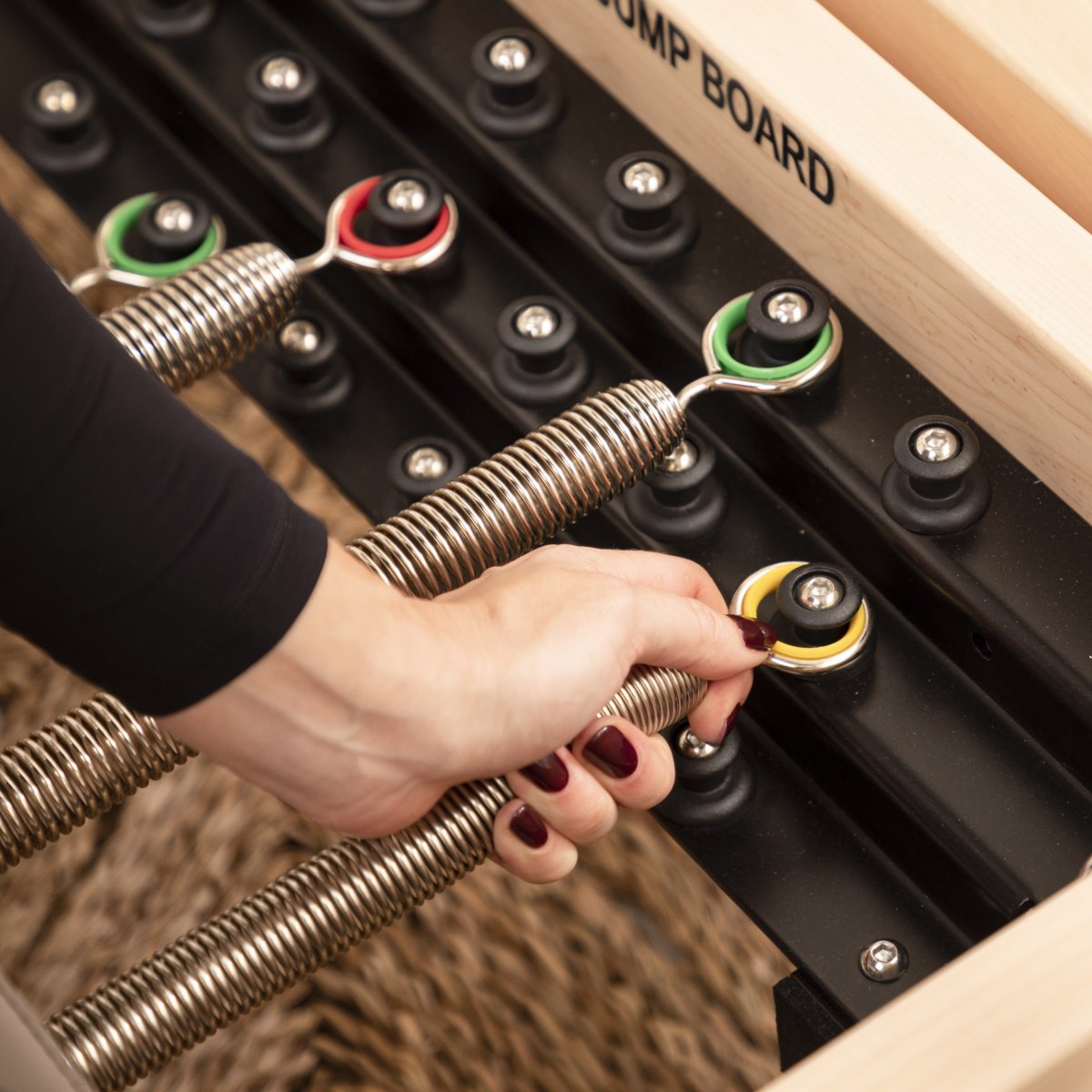 Close-up of durable resistance springs on the Elina Pilates Master Instructor™ Reformer showing tension and adjustment mechanisms