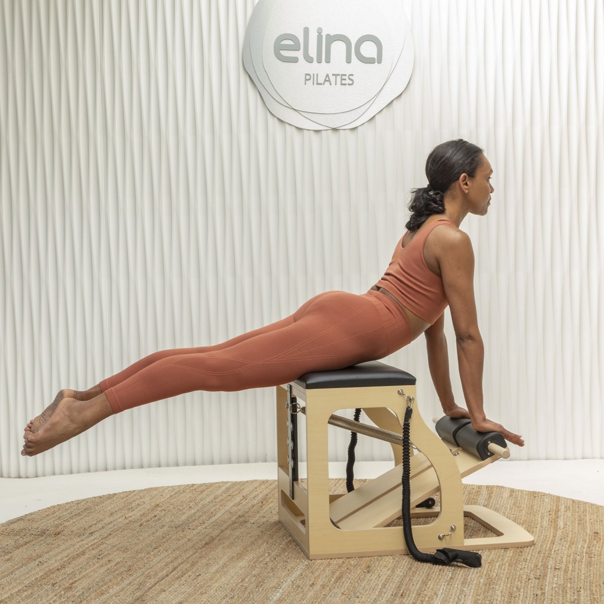 Woman using Elina Pilates Alma Chair