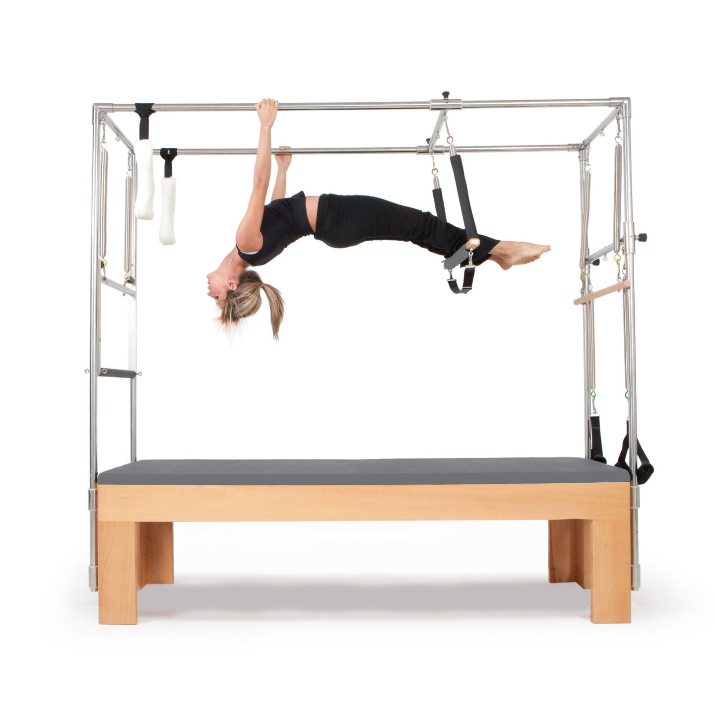 Pilates instructor demonstrating core strengthening exercises using the Elina Pilates Cadillac with grey upholstery