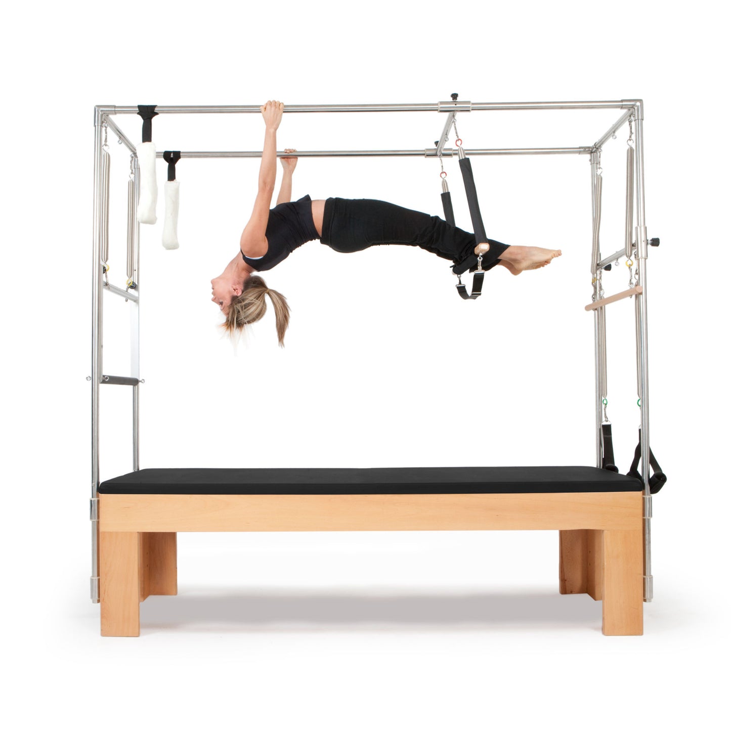 Pilates instructor demonstrating core strengthening exercises using the Elina Pilates Cadillac with black upholstery