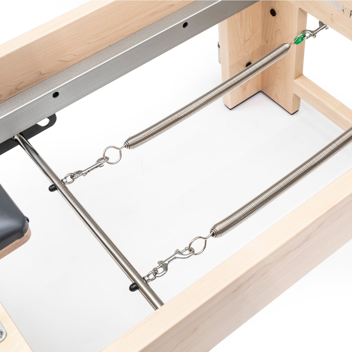 Close-up of the smooth eight-wheel carriage system and two-piece rail on the Elite Cadillac Reformer