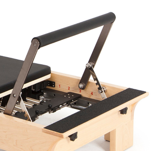 Close-up of the adjustable footbar on the Elina Pilates Wooden Half-Trapeze Tower Reformer.