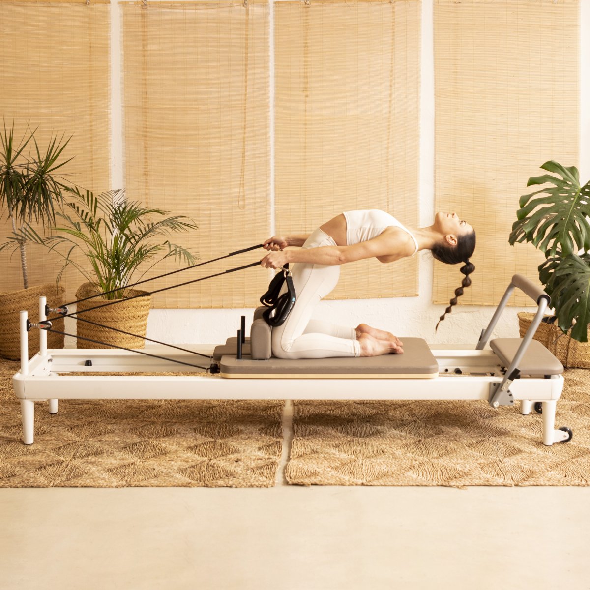 Pilates instructor demonstrating exercises on the Elina Pilates Nubium Reformer in a studio setting