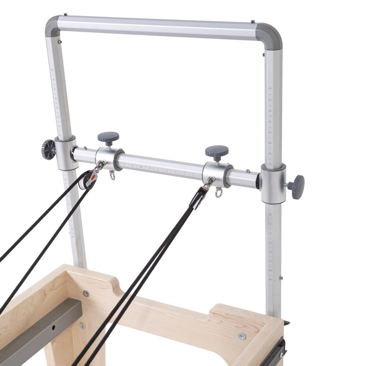Close-up view of the Elina Pilates Physio Reformer’s mini-tower with adjustable pulleys and hexagonal grip handles in black upholstery