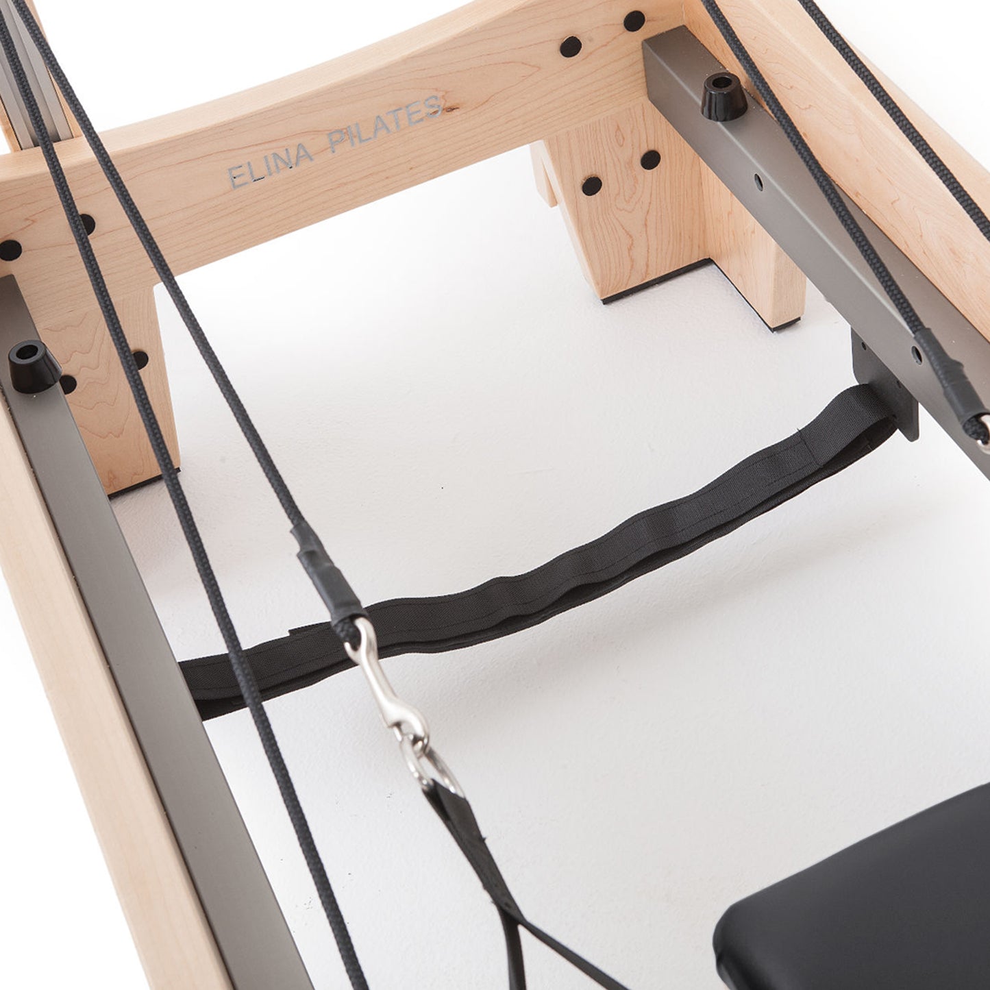 Heavy-duty spring resistance system on Elina Pilates Wood Reformer with Tower Pro for adjustable workout intensity.