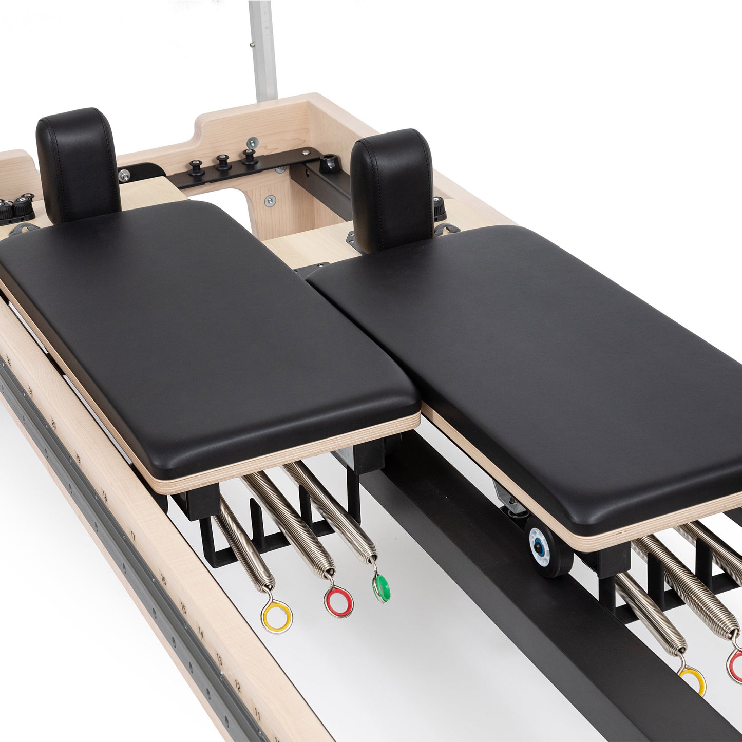 Close-up of the twin double-carriage system on Elina Reformer with precision wheels and glide rails