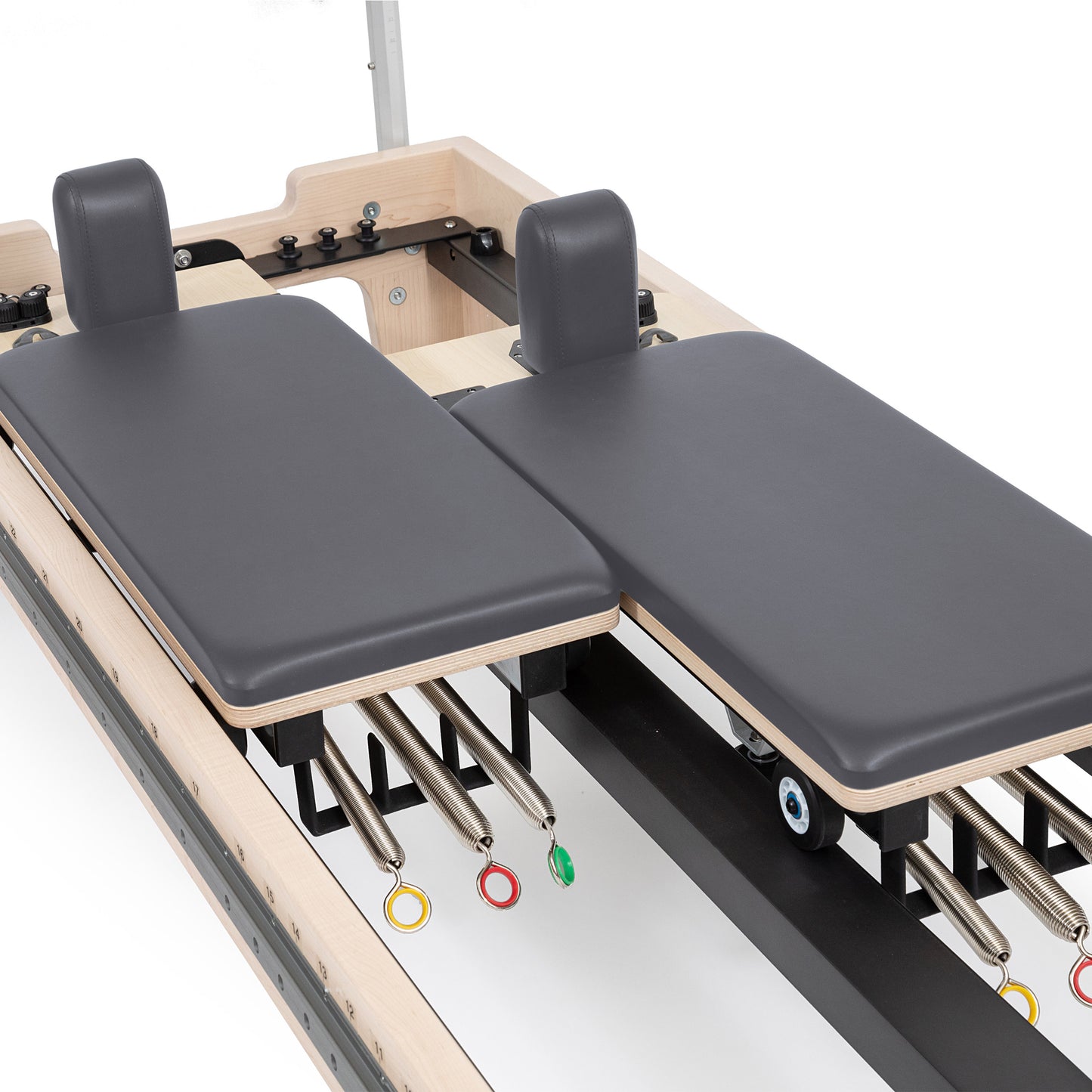 Close-up of the twin double-carriage system on Elina Reformer with precision wheels and glide rails
