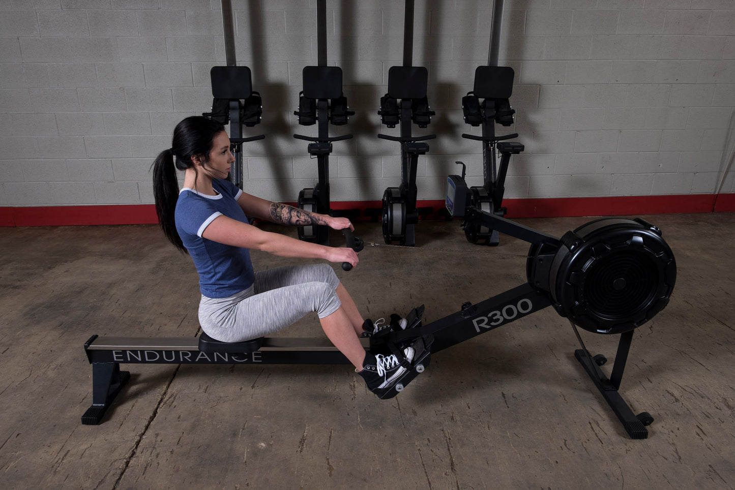 Athlete using the Endurance R300 Indoor Rower for full-body cardio workout