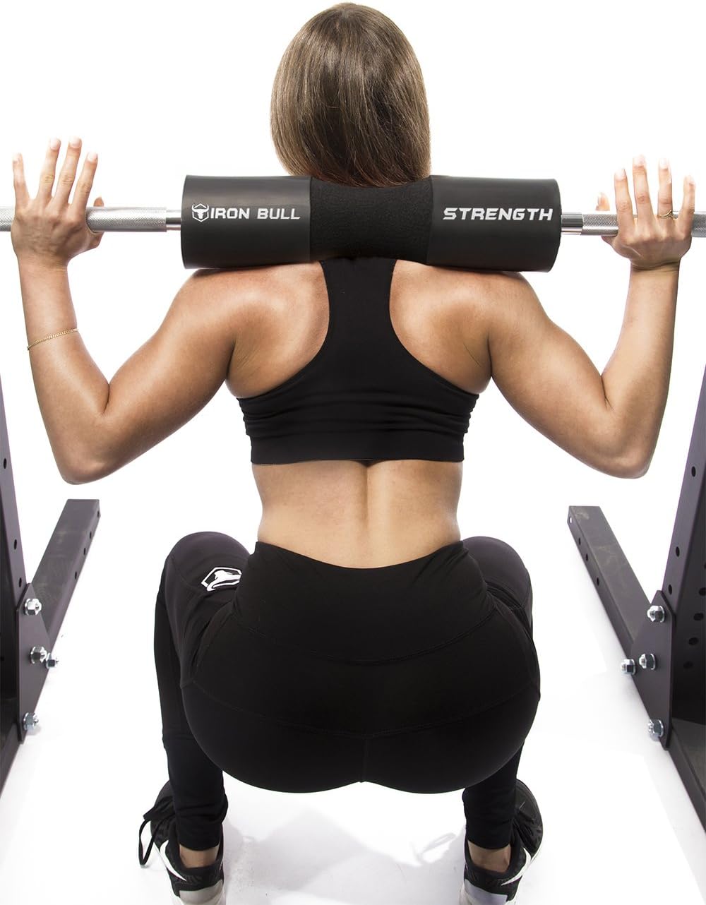 Athlete performing barbell squat using Iron Bull Strength squat pad