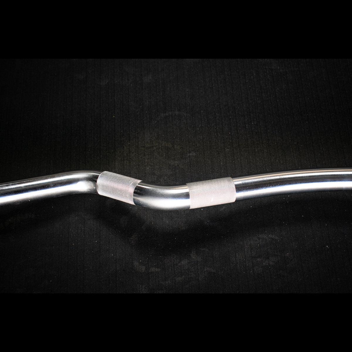 Close-up of ergonomic angled grip on curl bar
