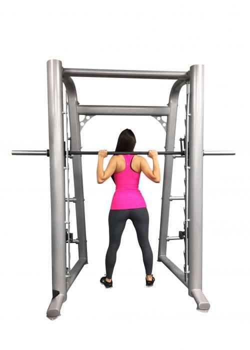 User doing squat on the Muscle D Fitness Smith Machine