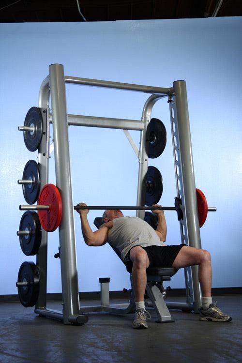 User performing inclined press on the Muscle D Fitness Smith Machine