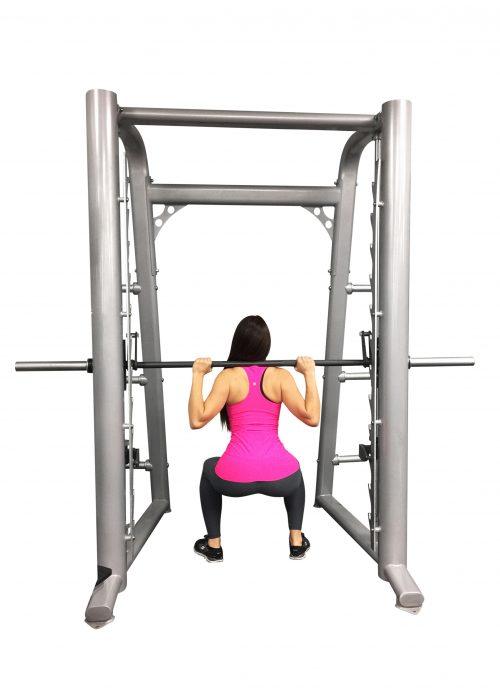 User performing squat on Muscle D Fitness Smith Machine