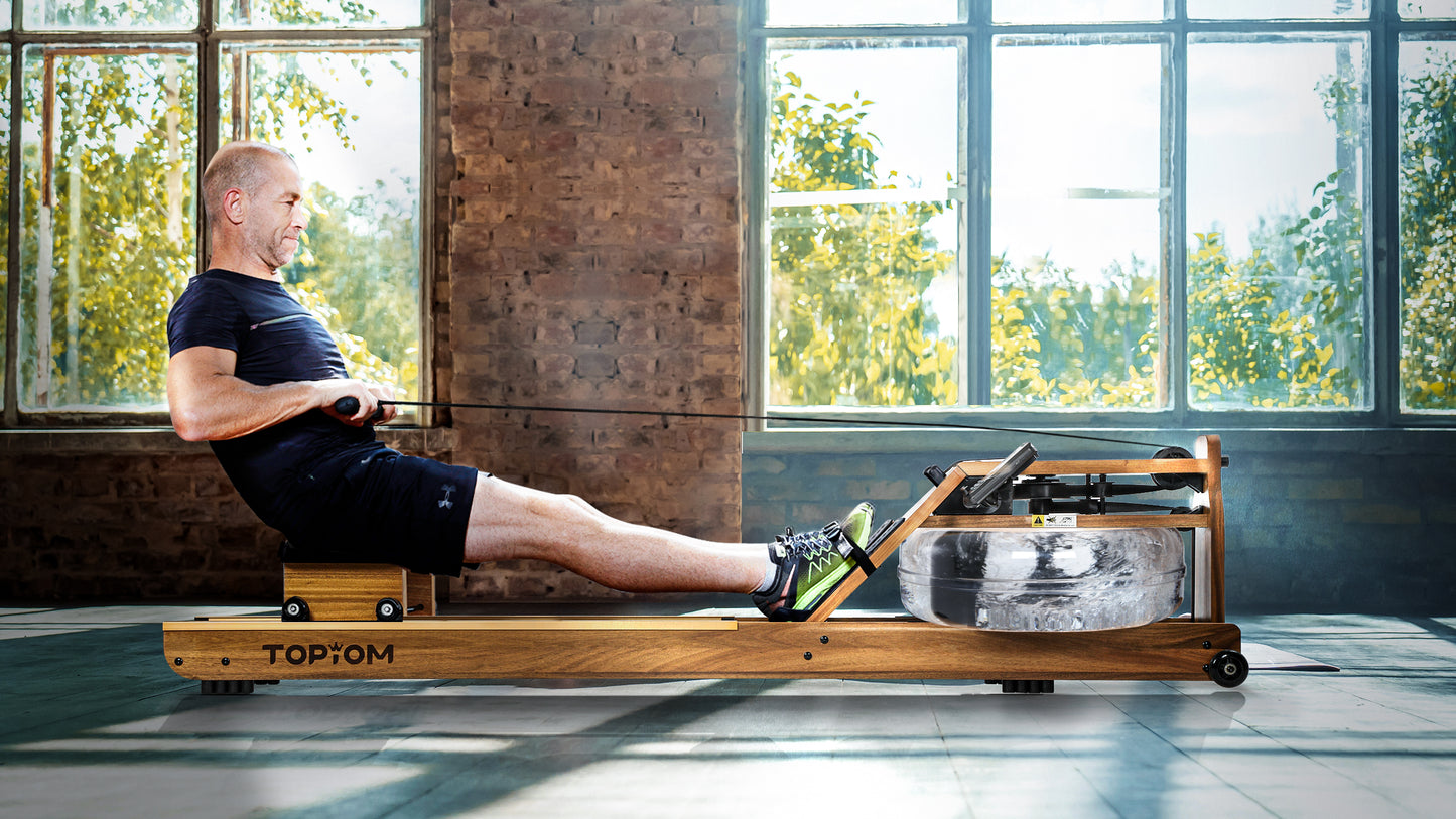 A person using their Topiom Golden Walnut wooden water rowing machines in their home