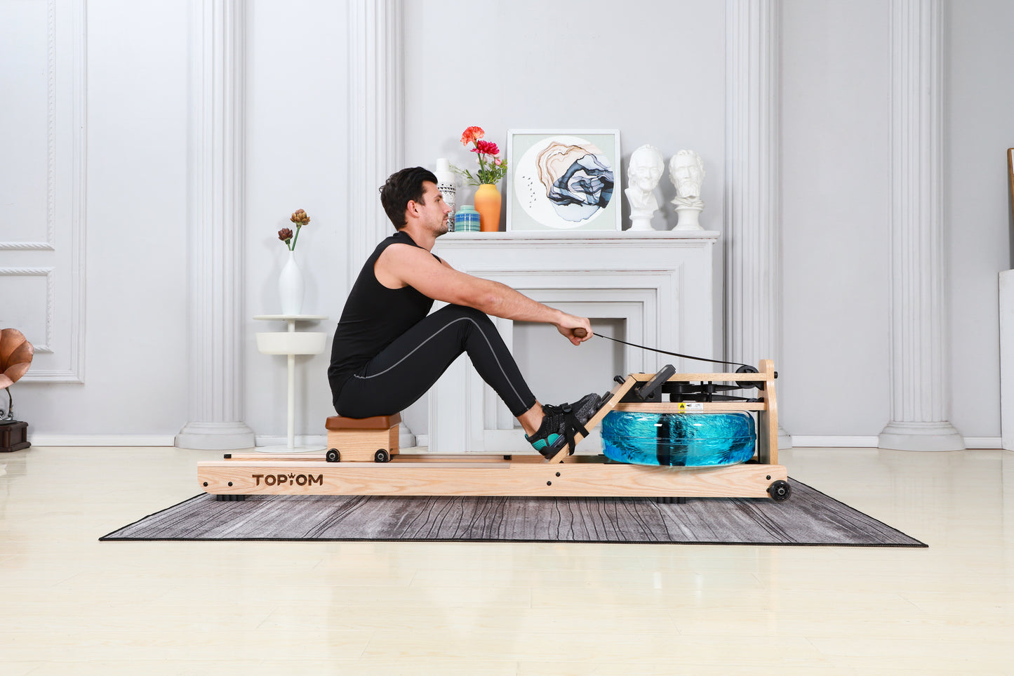 A person using their Topiom Natural wooden water rowing machines in their home