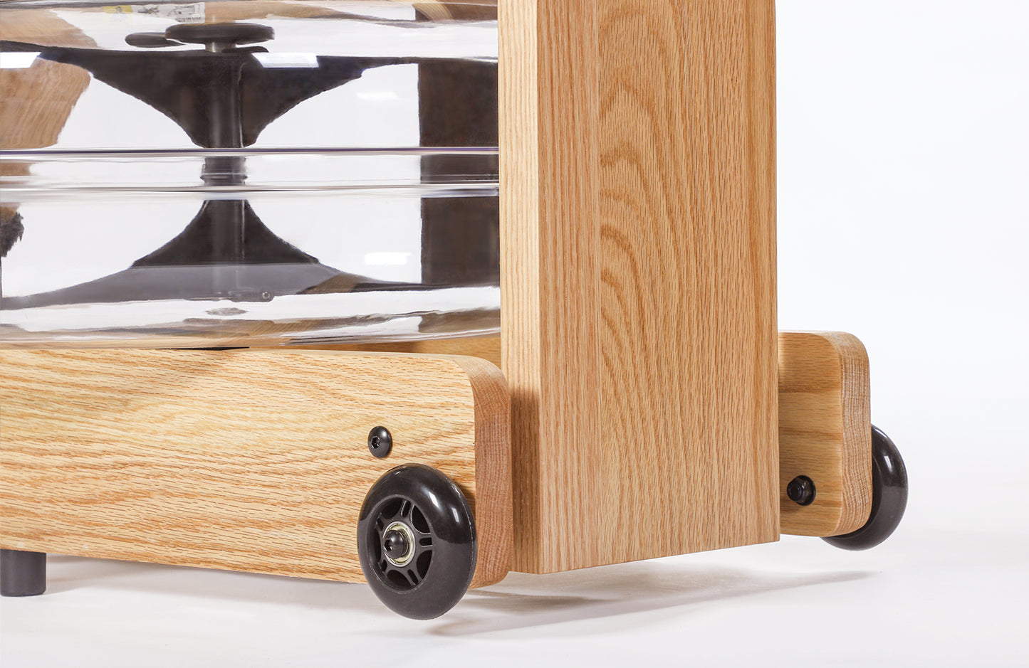 Closeup of easy transport wheels of the Topiom Natural Oak wooden water rowing machine.