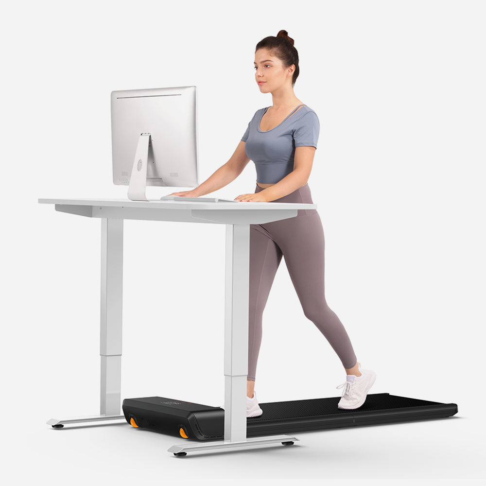 User working at desk while using the WalkingPad A1 Pro Foldable Treadmill