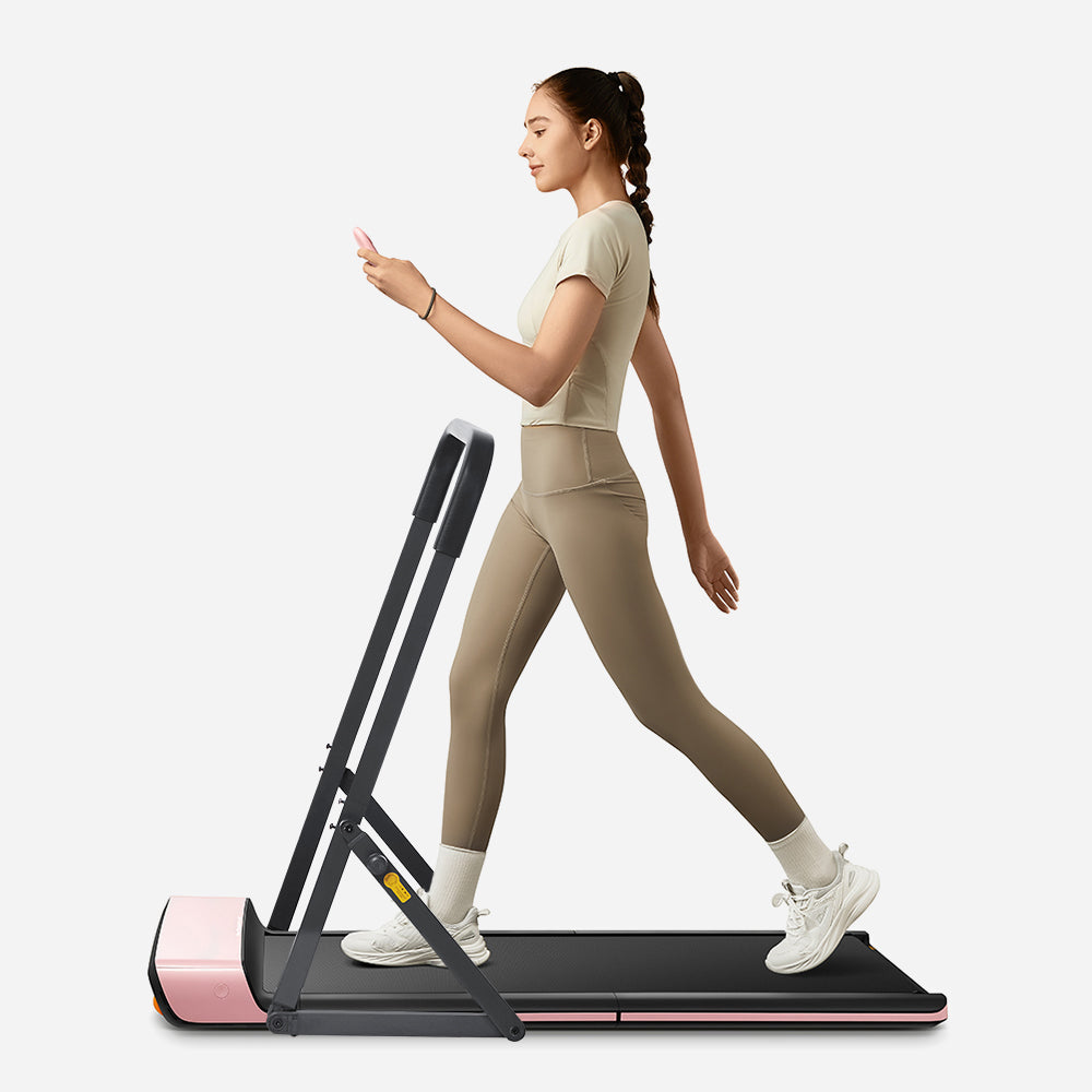 Side view of person using WalkingPad P1 Pink Foldable Treadmill