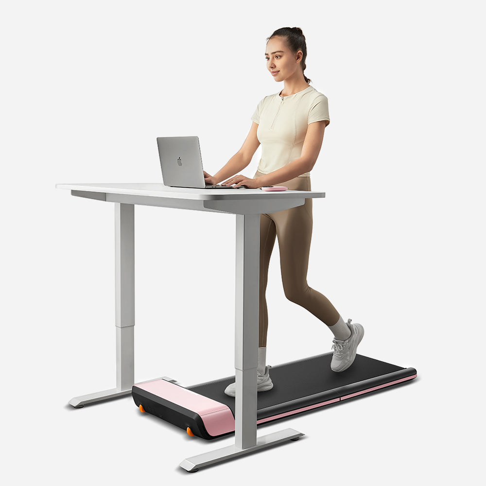 User walking on WalkingPad P1 Pink Foldable Treadmill under desk