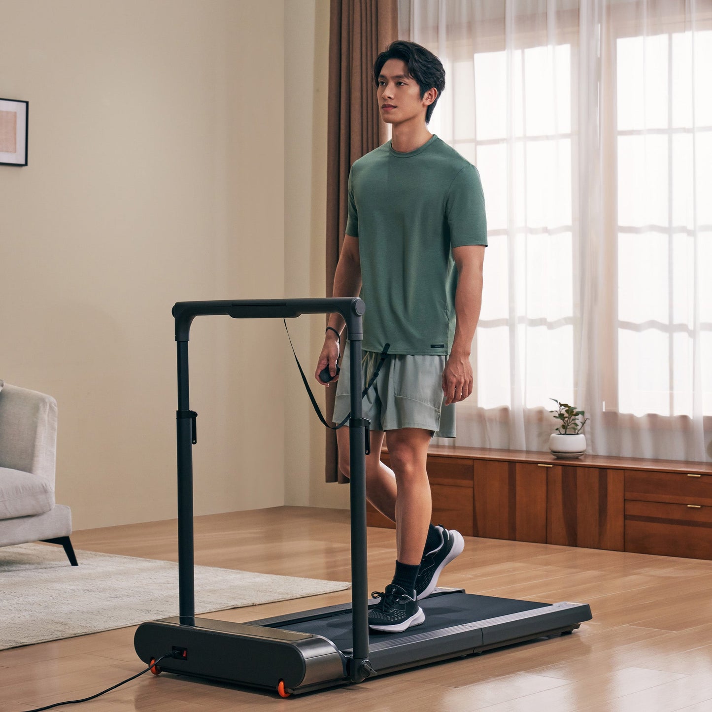 View of WalkingPad R3 Hybrid Foldable Treadmill being used in a home