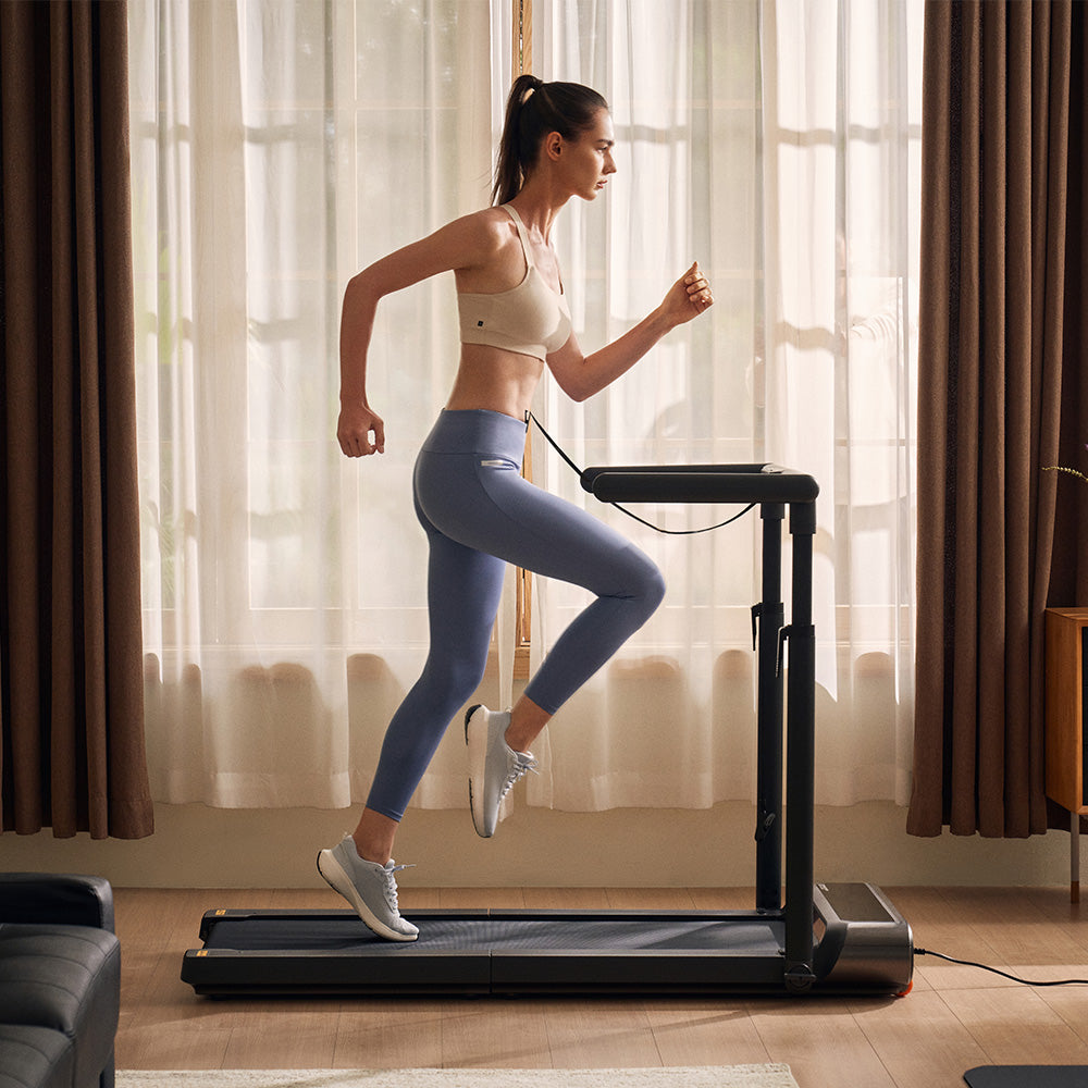 Woman running in home on the WalkingPad R3 Hybrid Plus