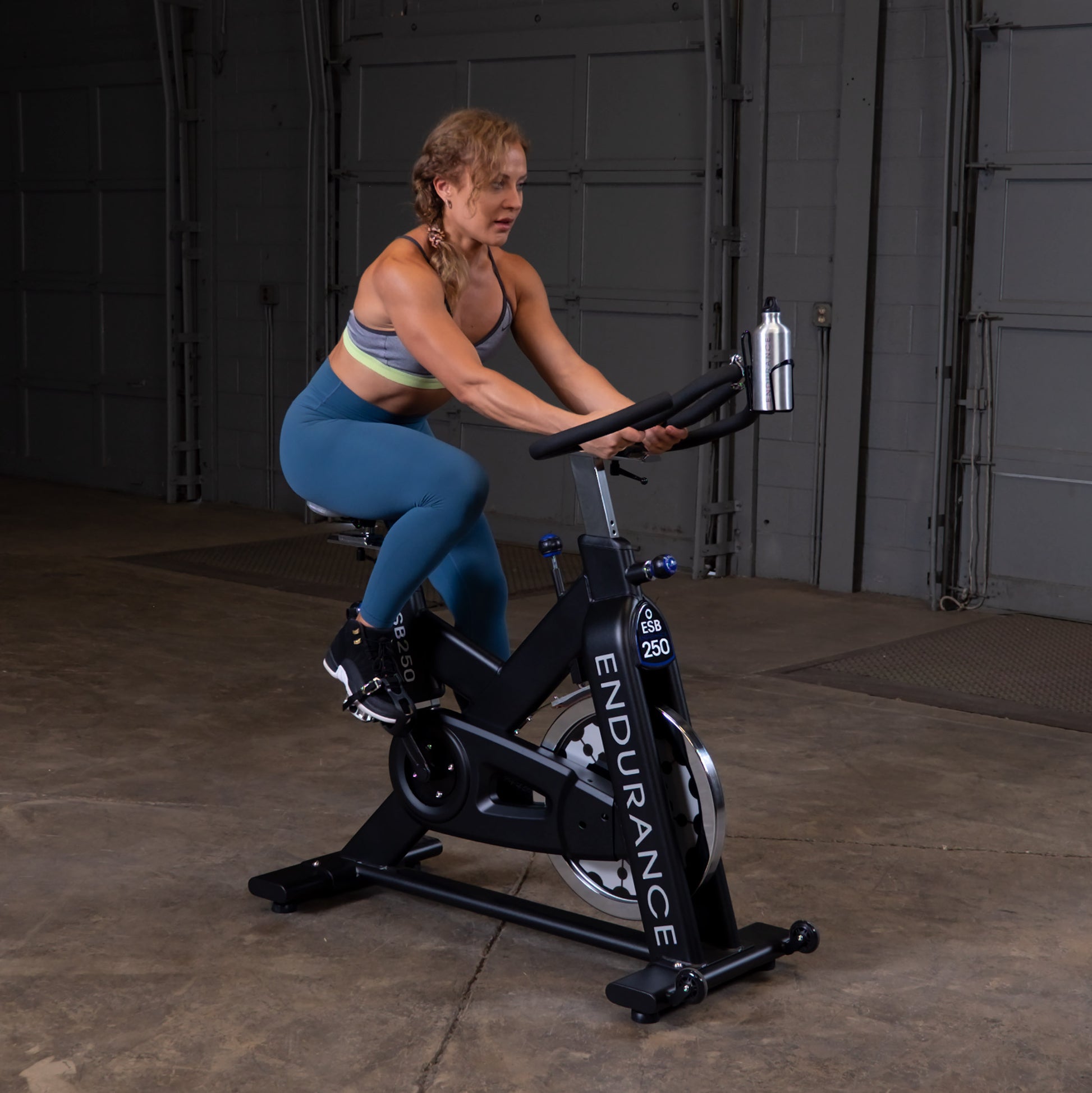 Body-Solid Endurance ESB250 spin bike set up in a modern home gym environment