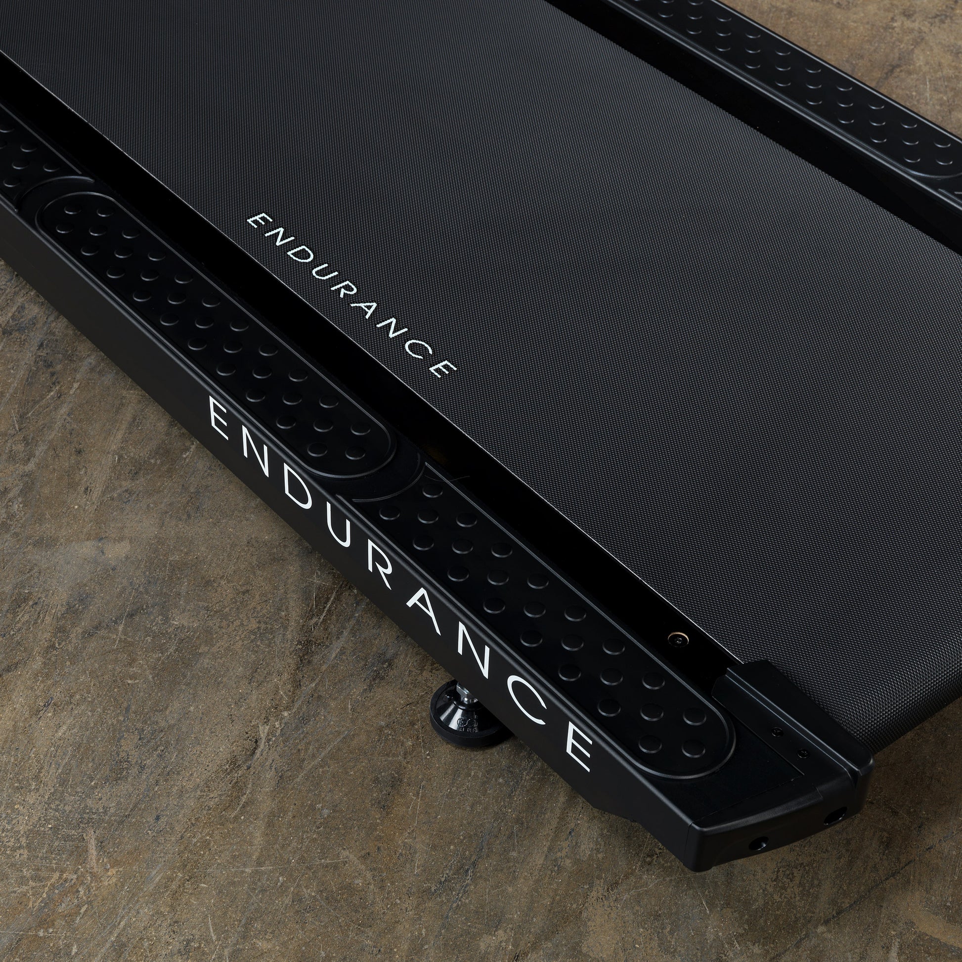 Durable, shock-absorbing running deck of the Body-Solid T150 treadmill designed for commercial use