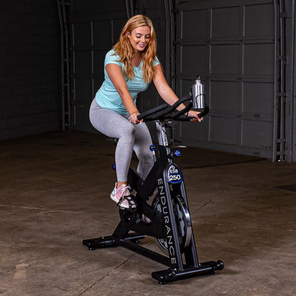 Woman spinning on the Endurance by Body-Solid ESB250 Spin Bike