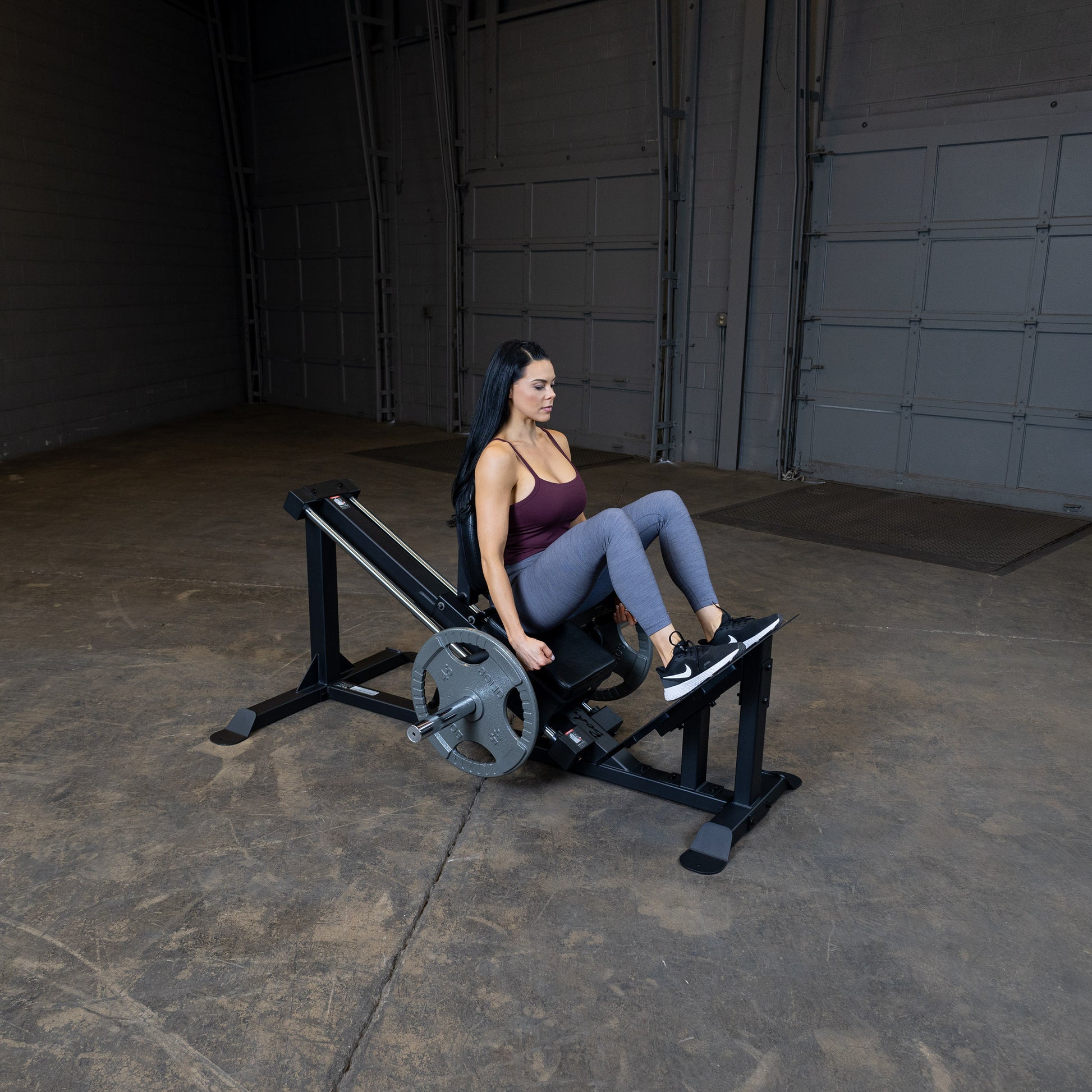 User performing leg press on Body-Solid GCLP100